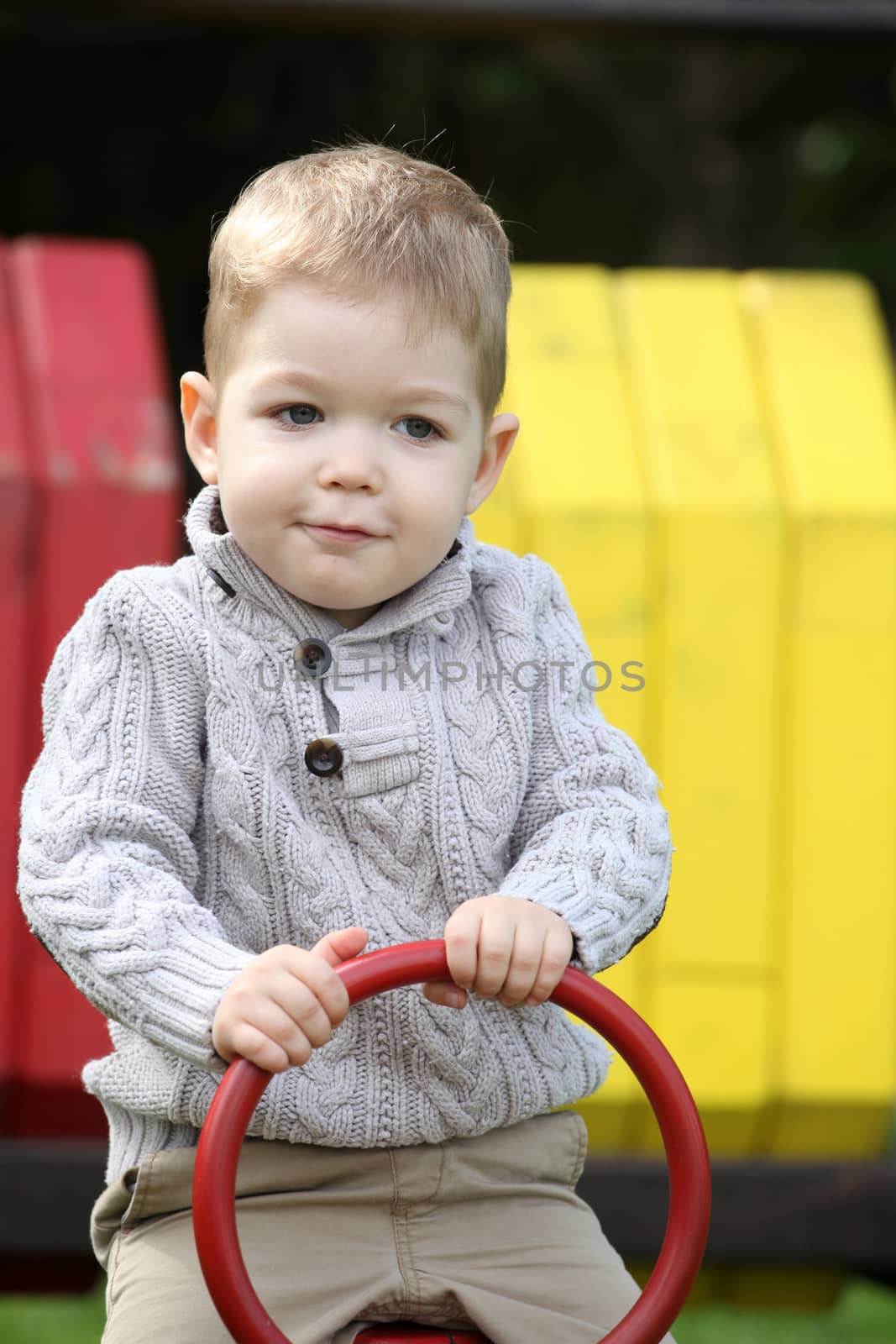 2 years old Baby boy on playground in spring outdoor park 