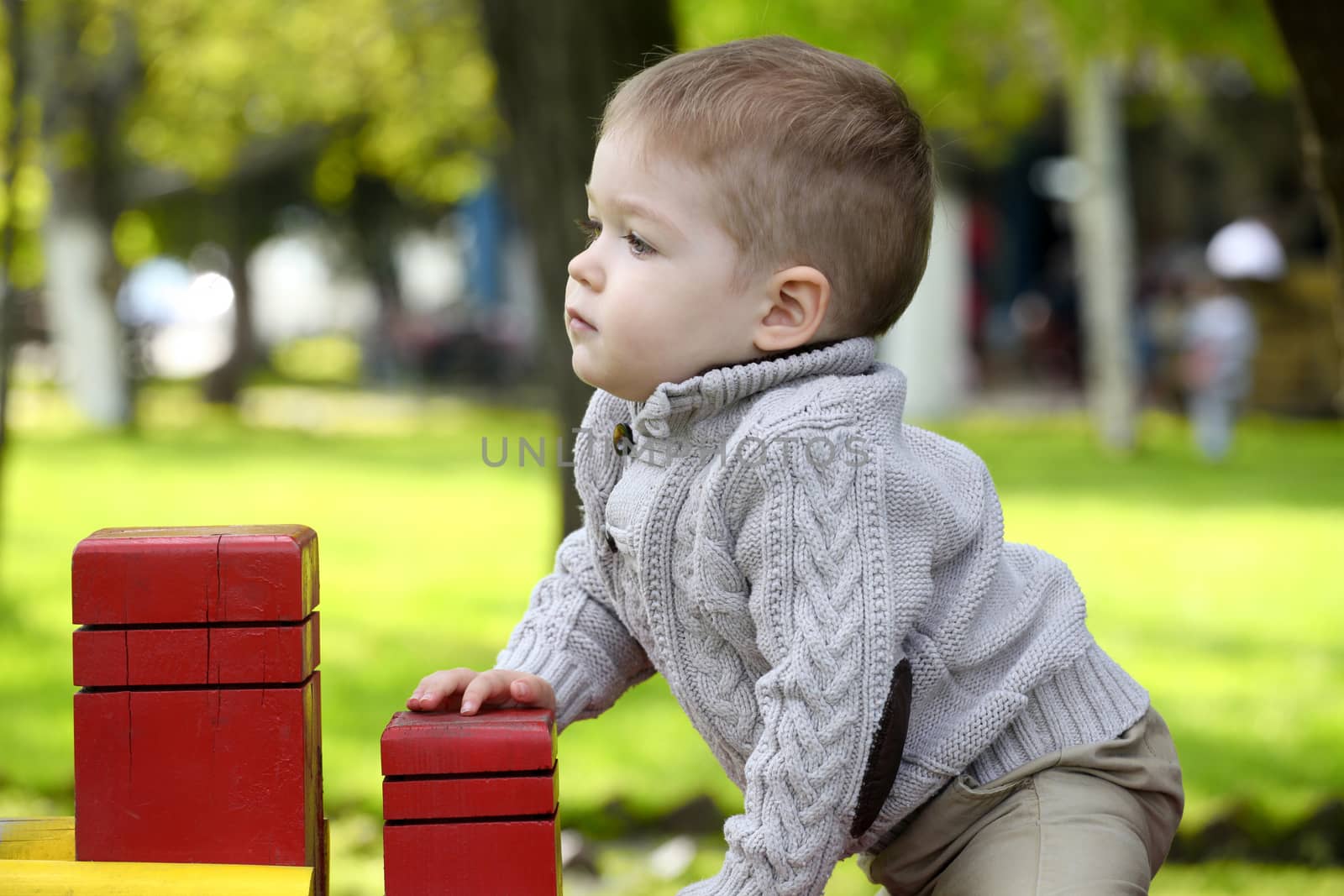 2 years old Baby boy on playground in spring outdoor park 