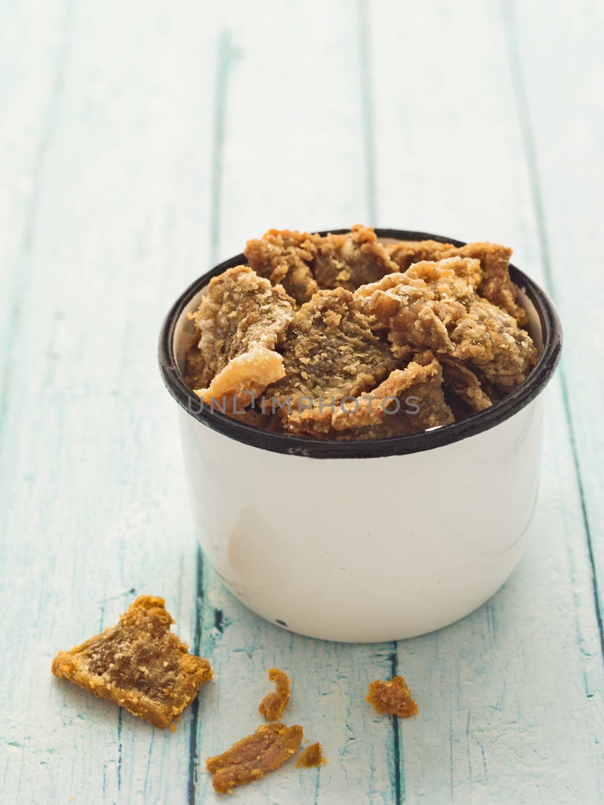 close up of rustic crispy deep fried salmon skin snack