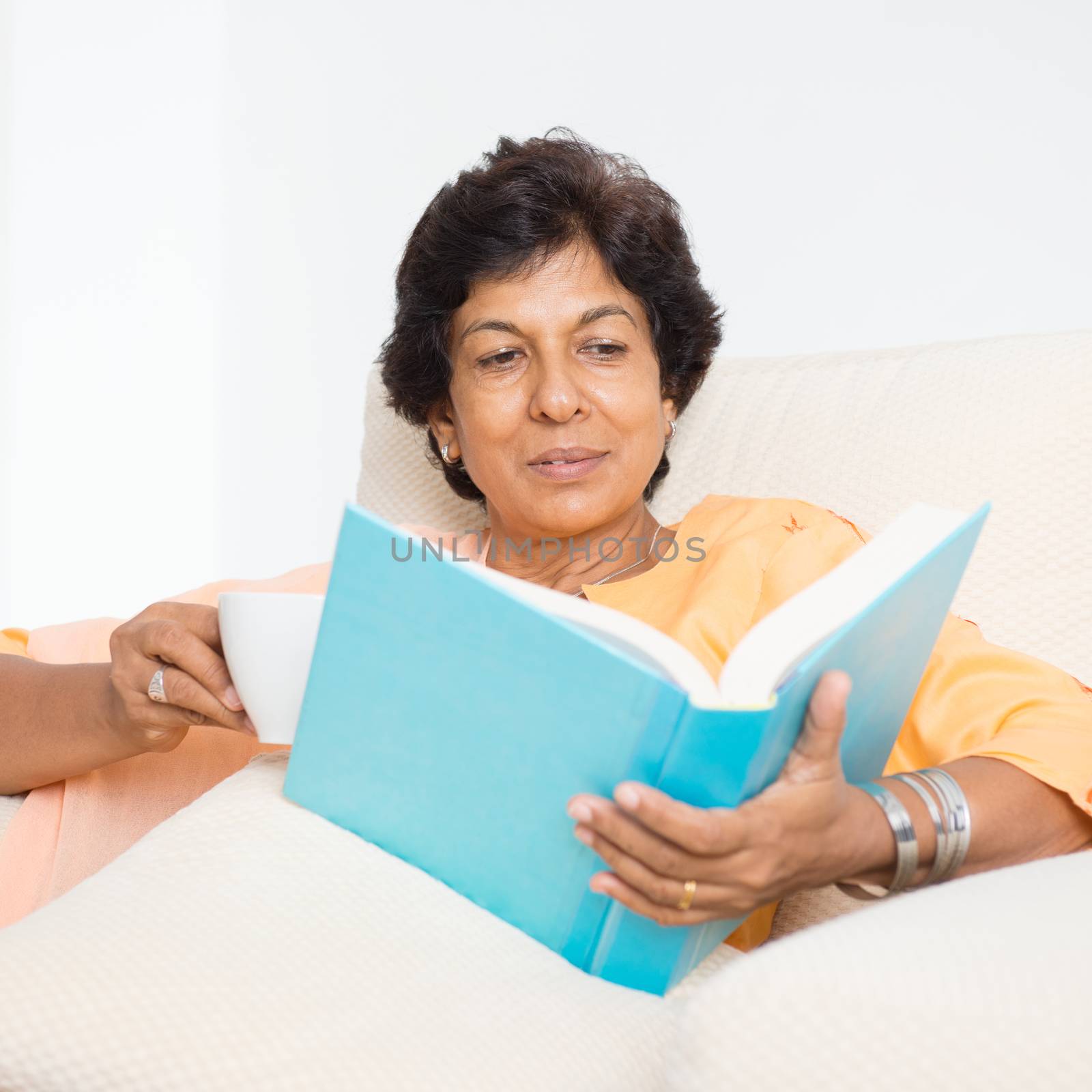 Indian mature woman reading book by szefei