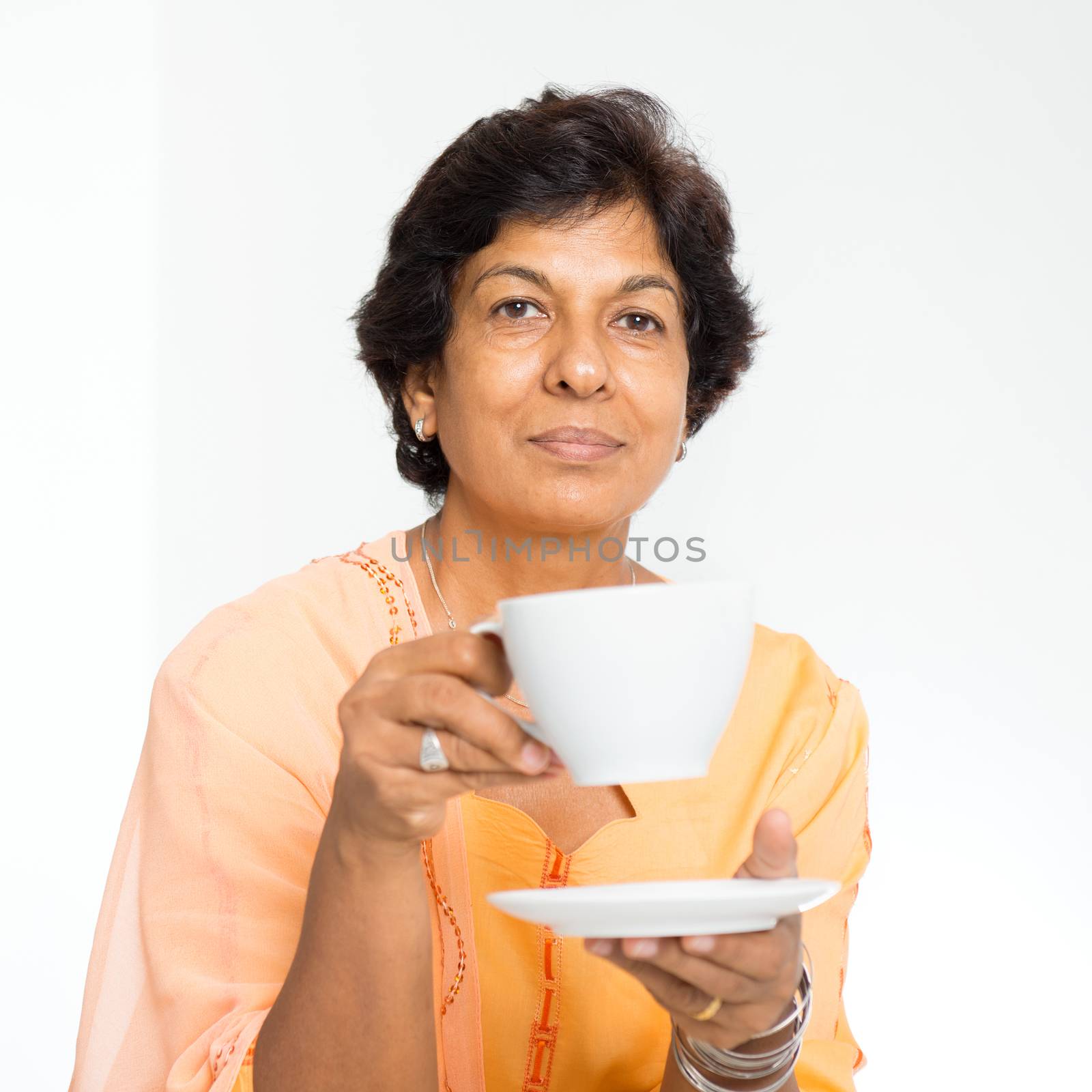 Indian mature woman drinking coffee by szefei