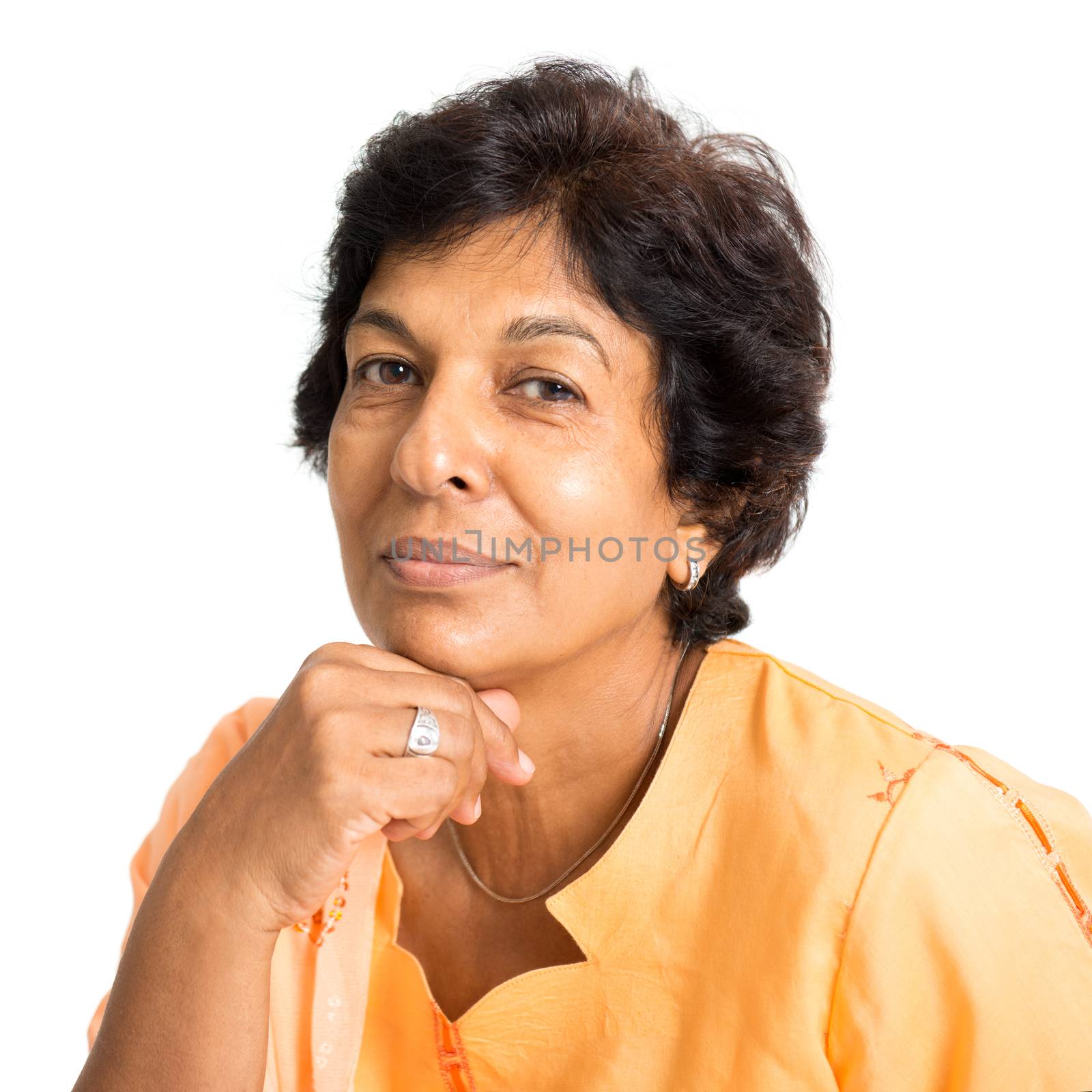 Portrait of a happy 50s Indian mature woman smiling and looking at camera, isolated on white background.