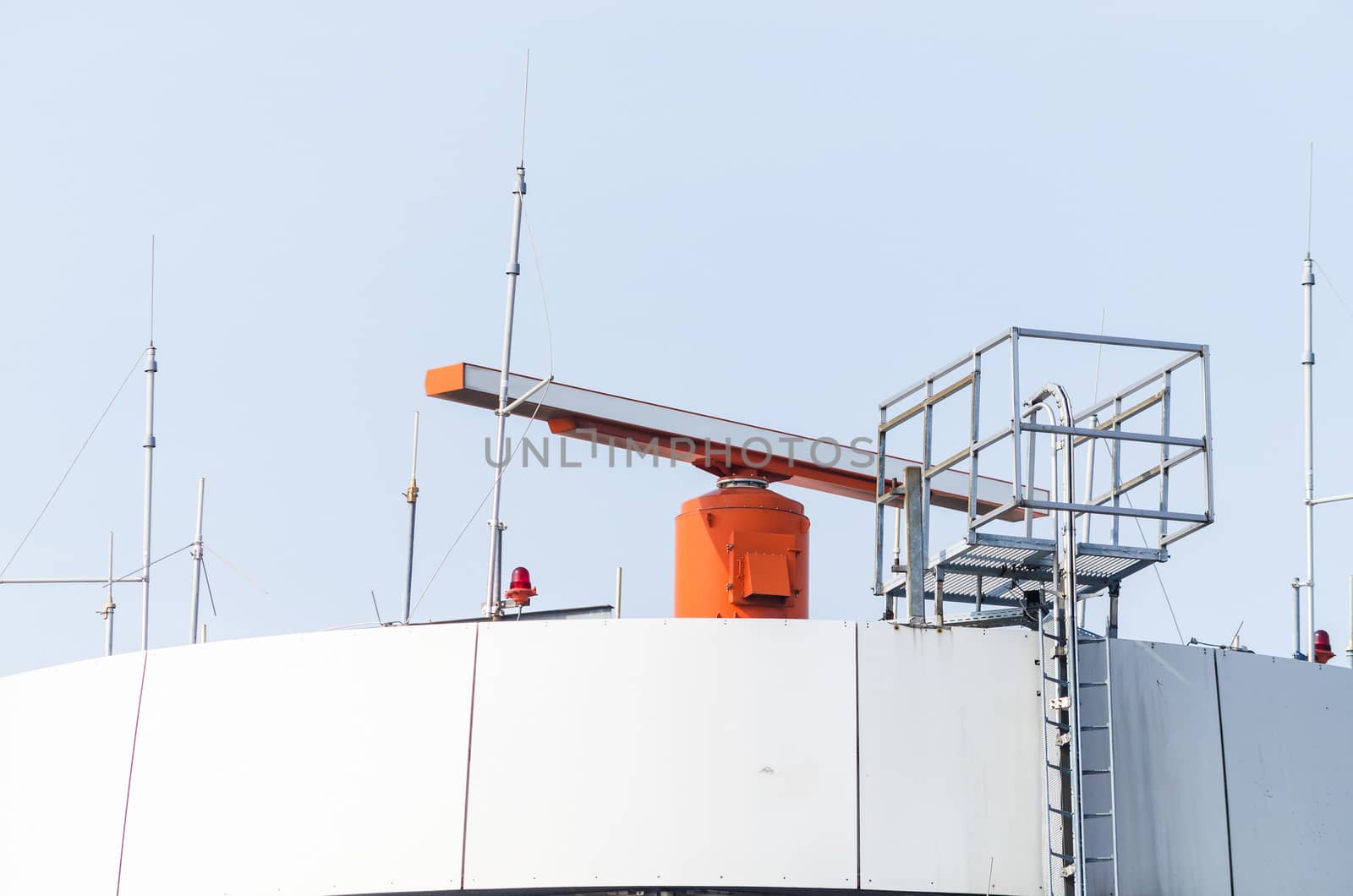 Tower at an international airport with radar on the roof.