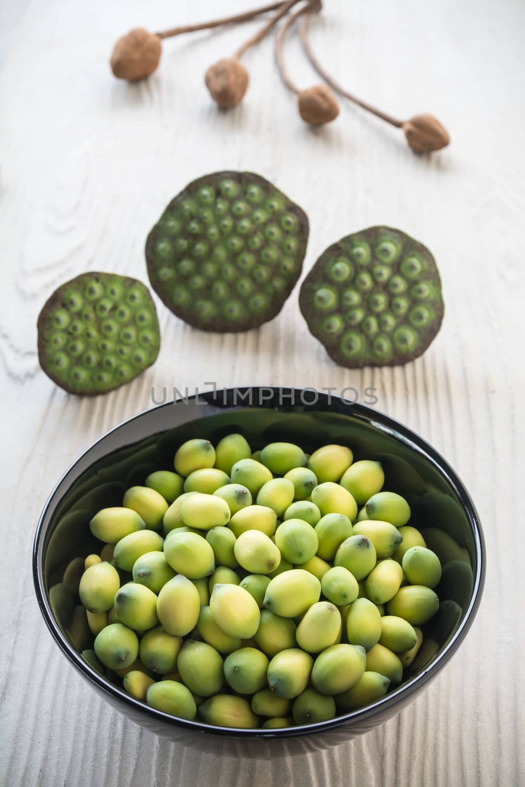 young lotus seeds in black bowl, eaten as snack in local Thailand