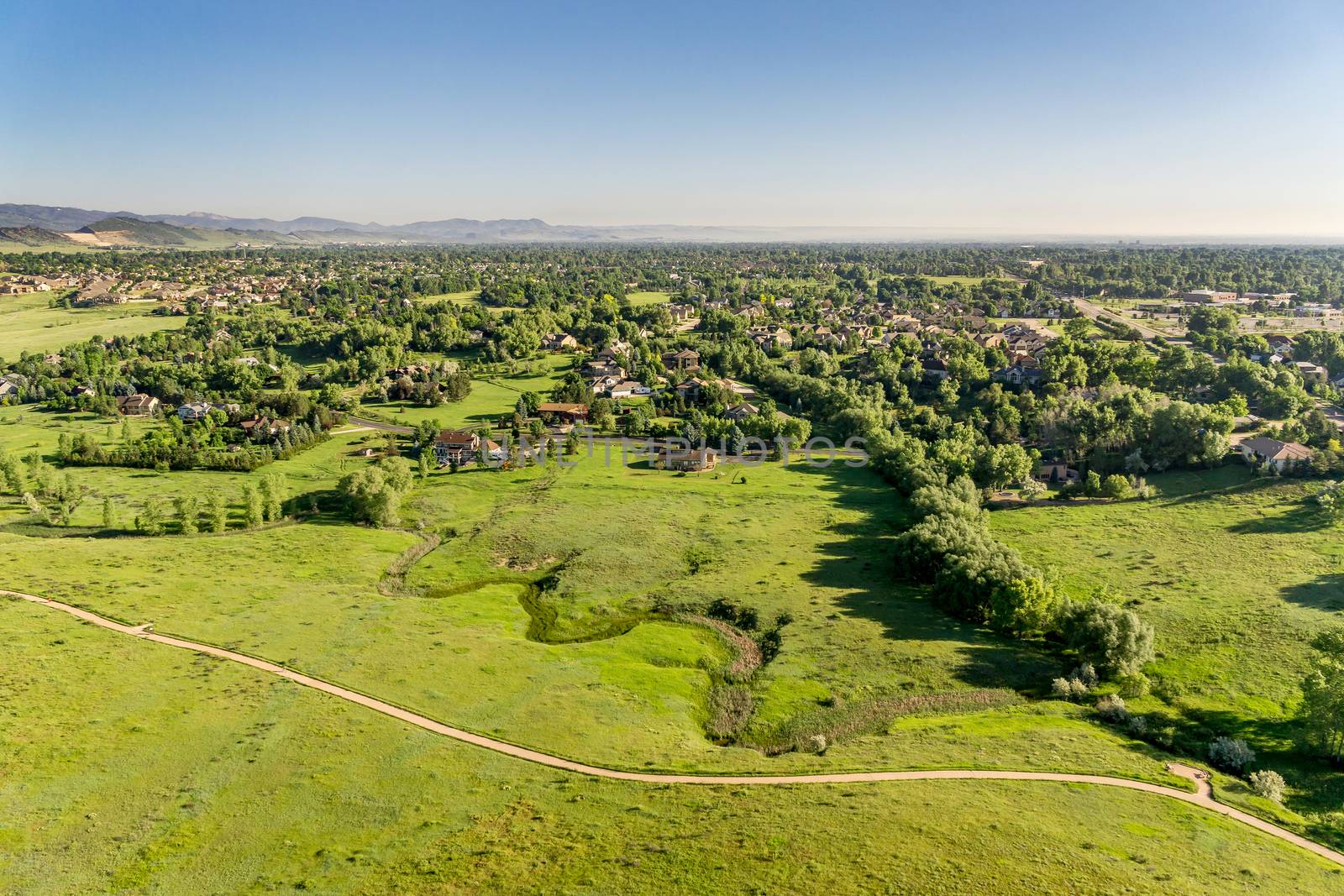 aerial view of foothills prairie in Colorado with a bike trail and residential area