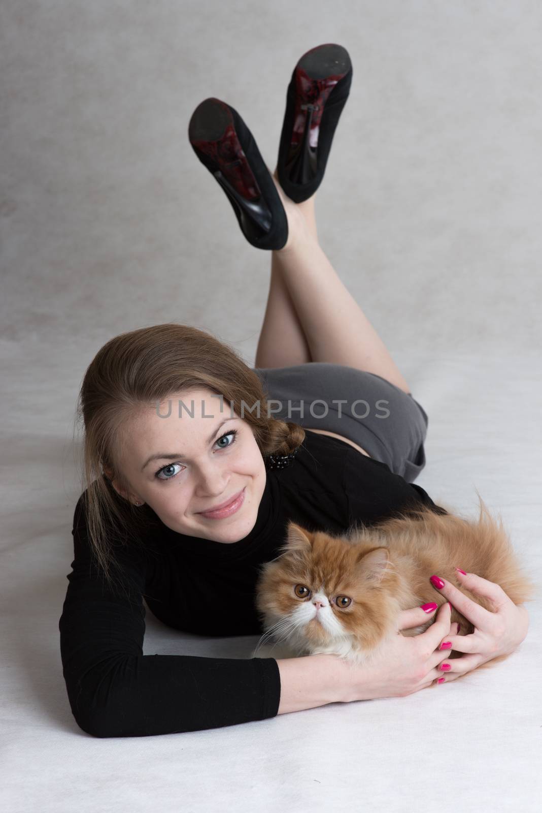 Very nice girl holds a red kitten by fotooxotnik