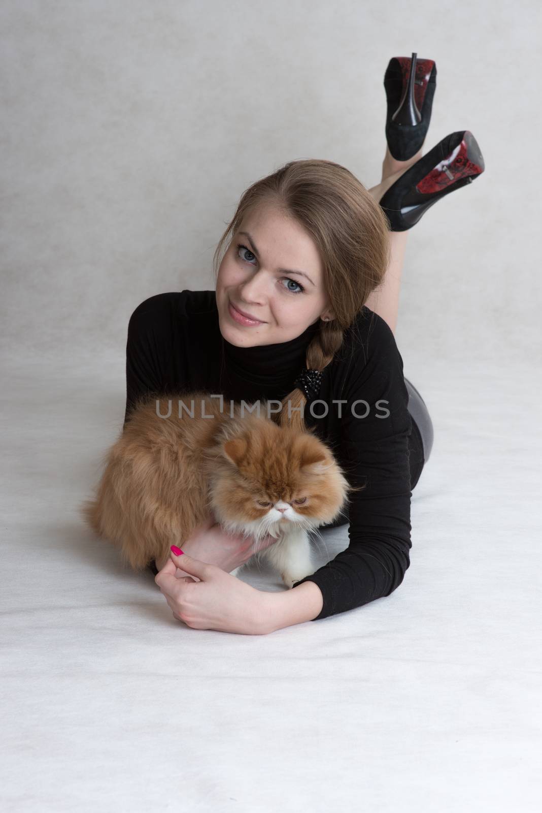 Very nice girl holds a red kitten by fotooxotnik