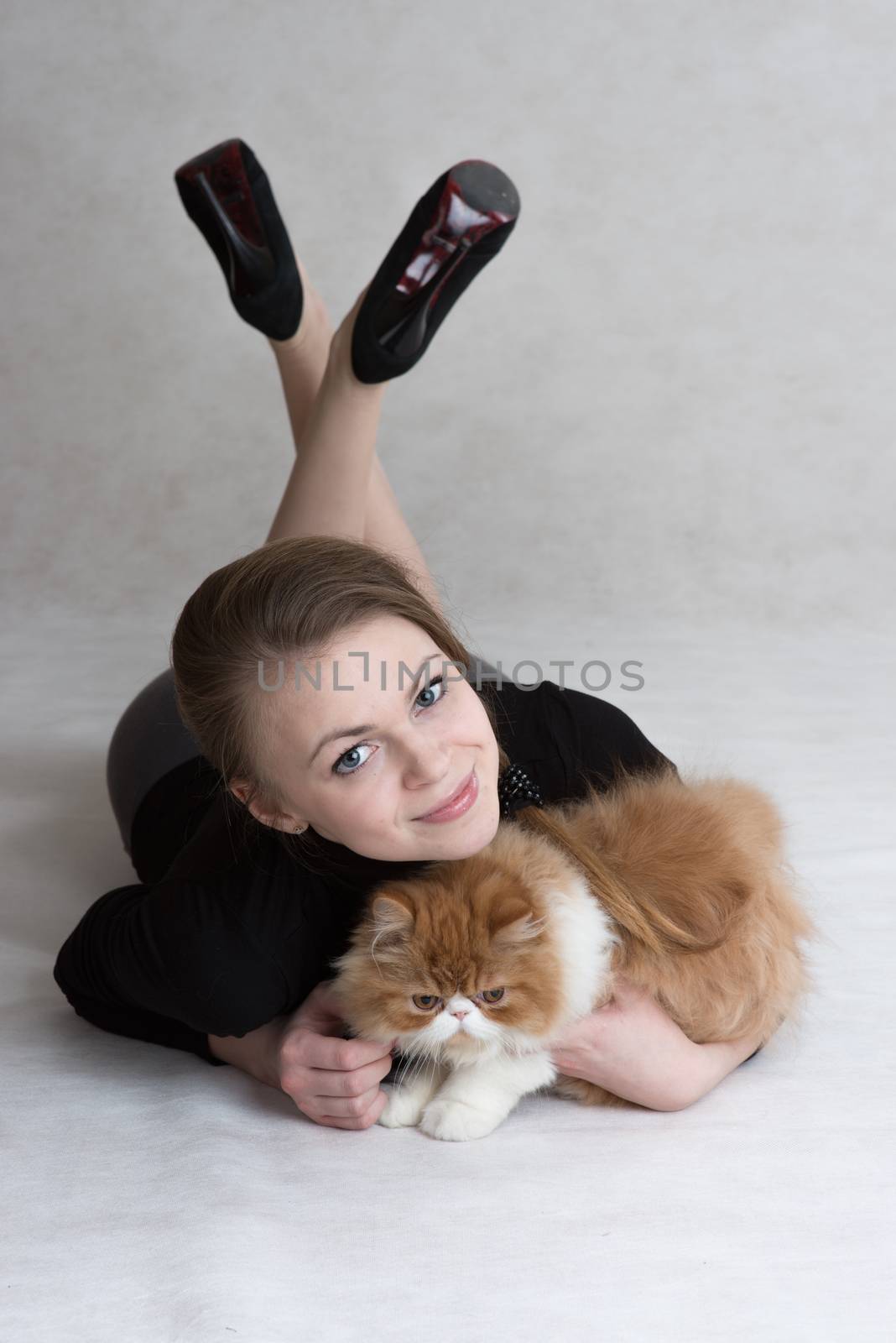 Very nice girl holds a red kitten by fotooxotnik