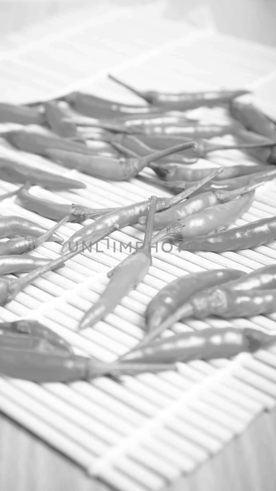 red chili peppers on wood table background black and white tone color style