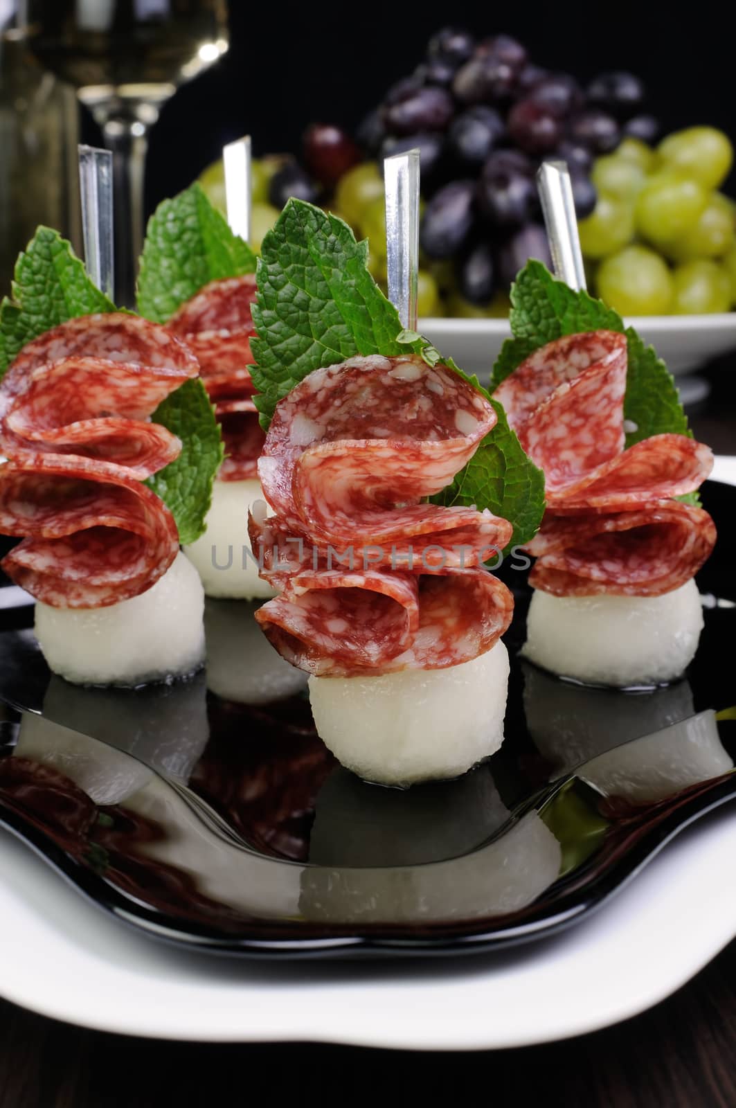 Canape of balls with a melon and salami by Apolonia