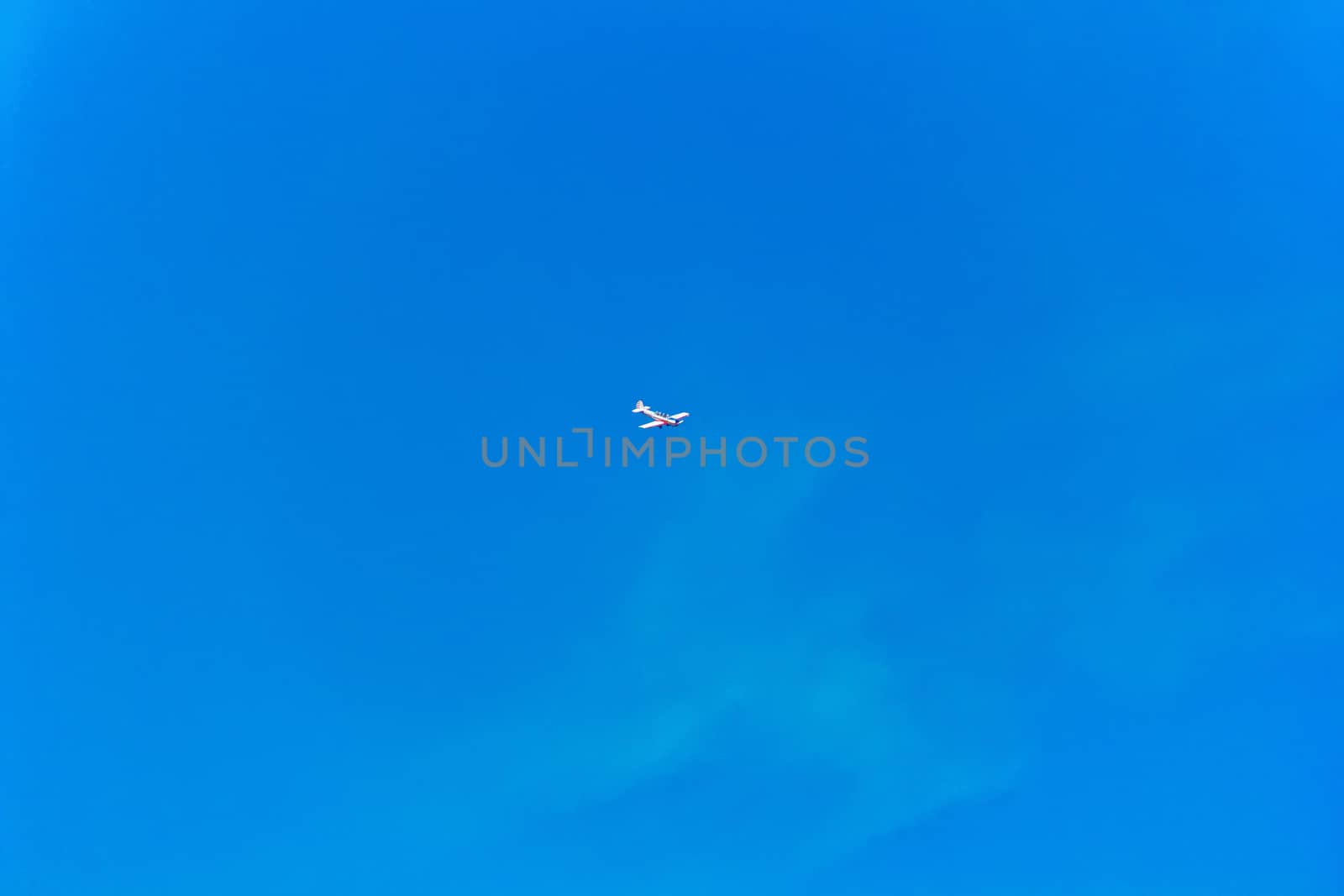Photo of flying military plane in blue sky