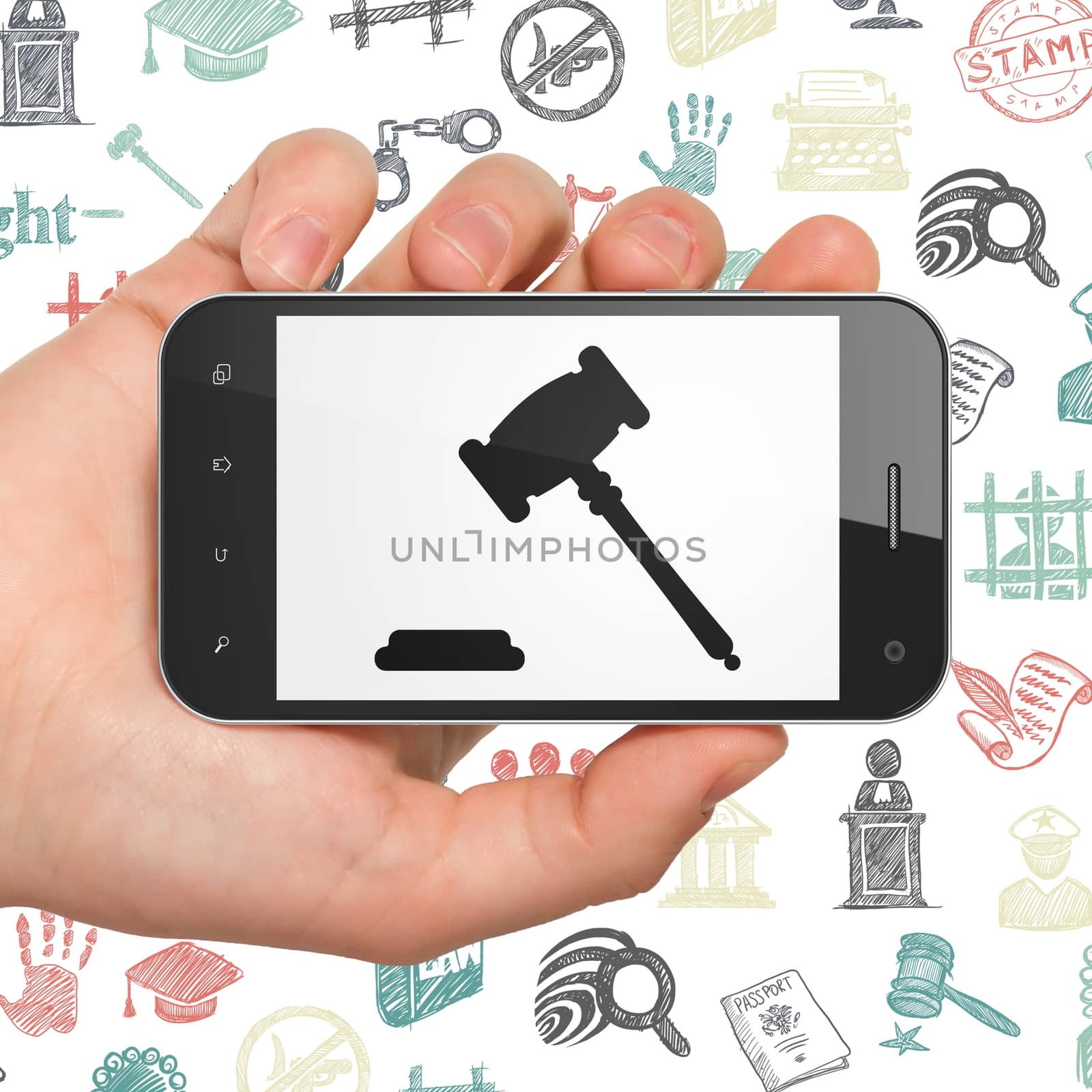 Law concept: Hand Holding Smartphone with Gavel on display by maxkabakov