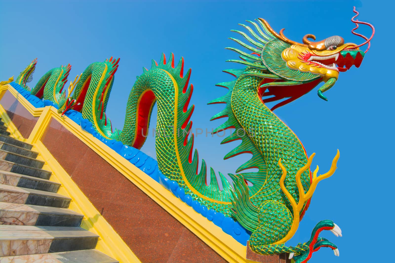 Chinese dragon guardian on stair way of  Wat Tha-Muang Temple in Thailand.