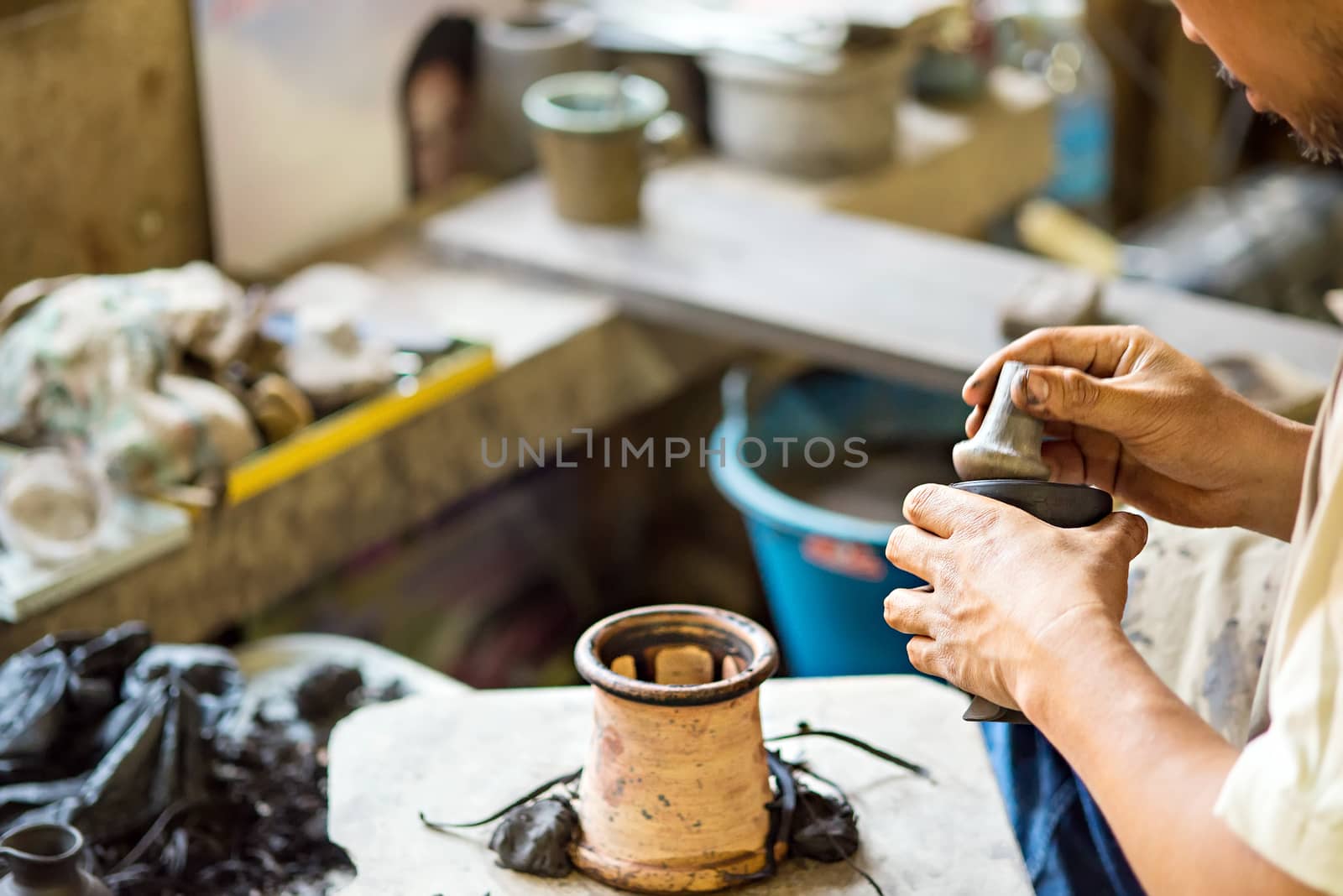 Hands working on pottery wheel of thailand