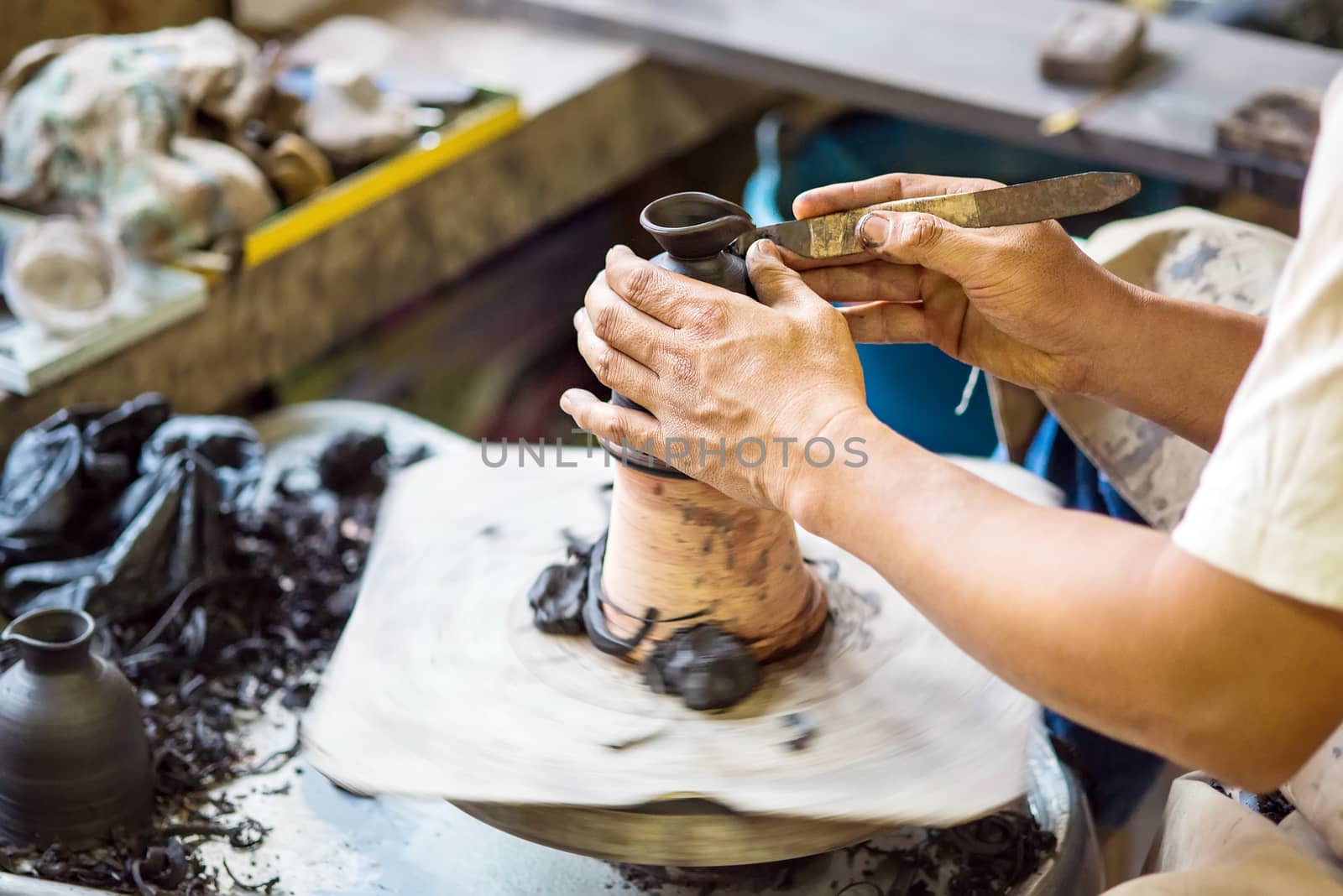 Hands working on pottery wheel by Yuri2012