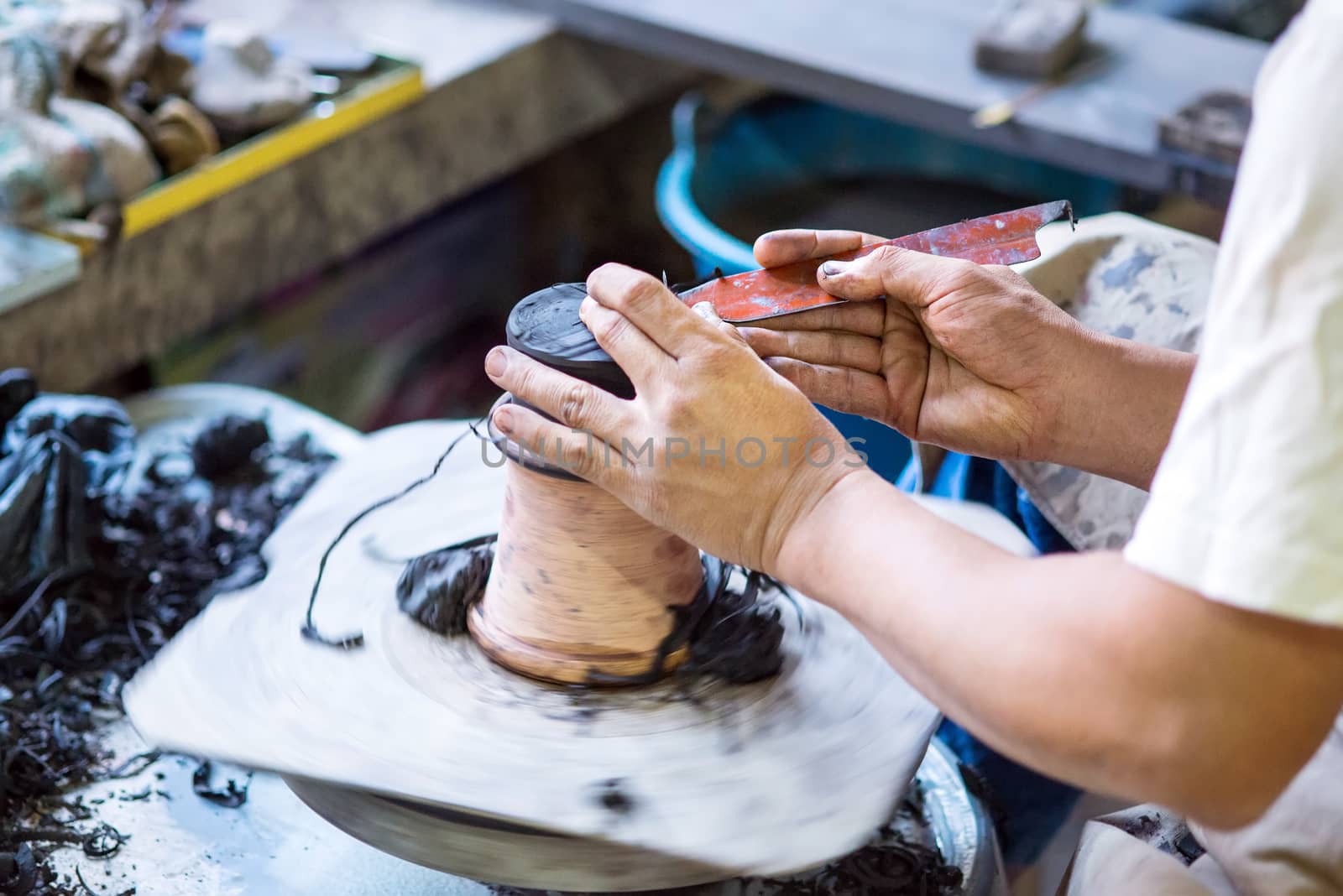 Hands working on pottery wheel of thailand