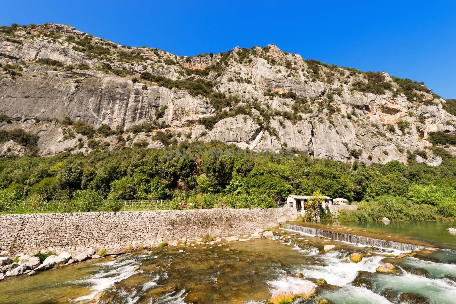 Rock walls for free climbing in Arco of Trento and Sarca river near the Garda Lake in Trentino Alto Adige, Italy, Europe