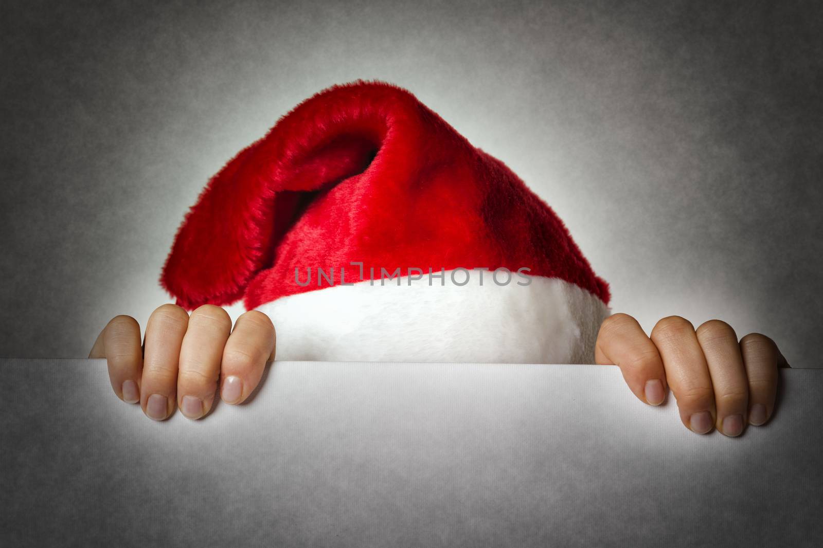 Image of Santa woman hiding behind a wall