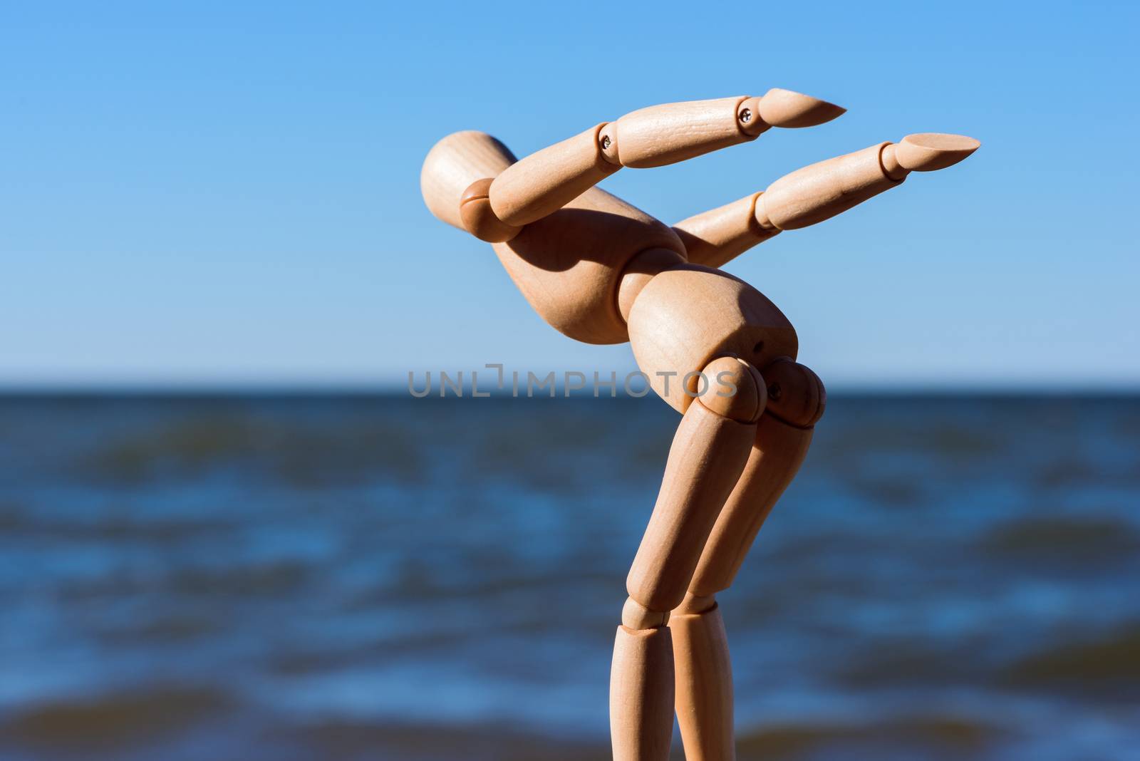 Mannequin stands on the stone and prepares to jump in water