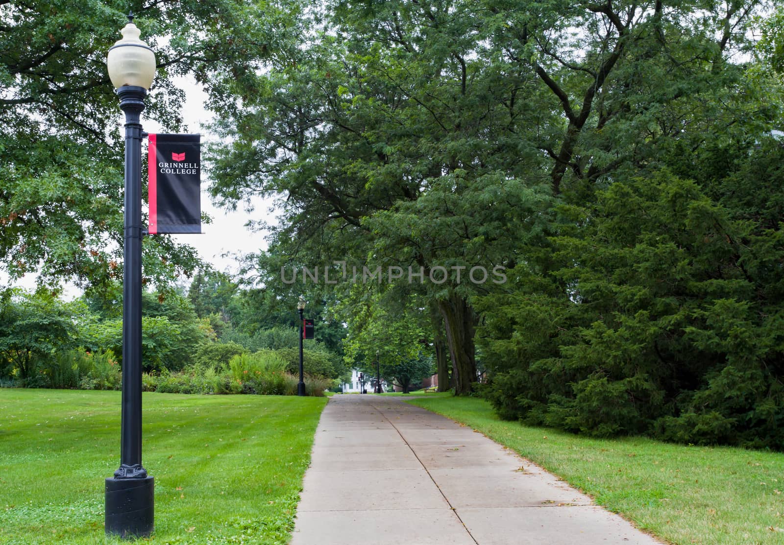 GRINNELL, IA/USA - AUGUST 8, 2015: Wooded path and sign on the campus of Grinell College. Grinnell College is a private liberal arts college  known for its rigorous academics and tradition of social responsibility.