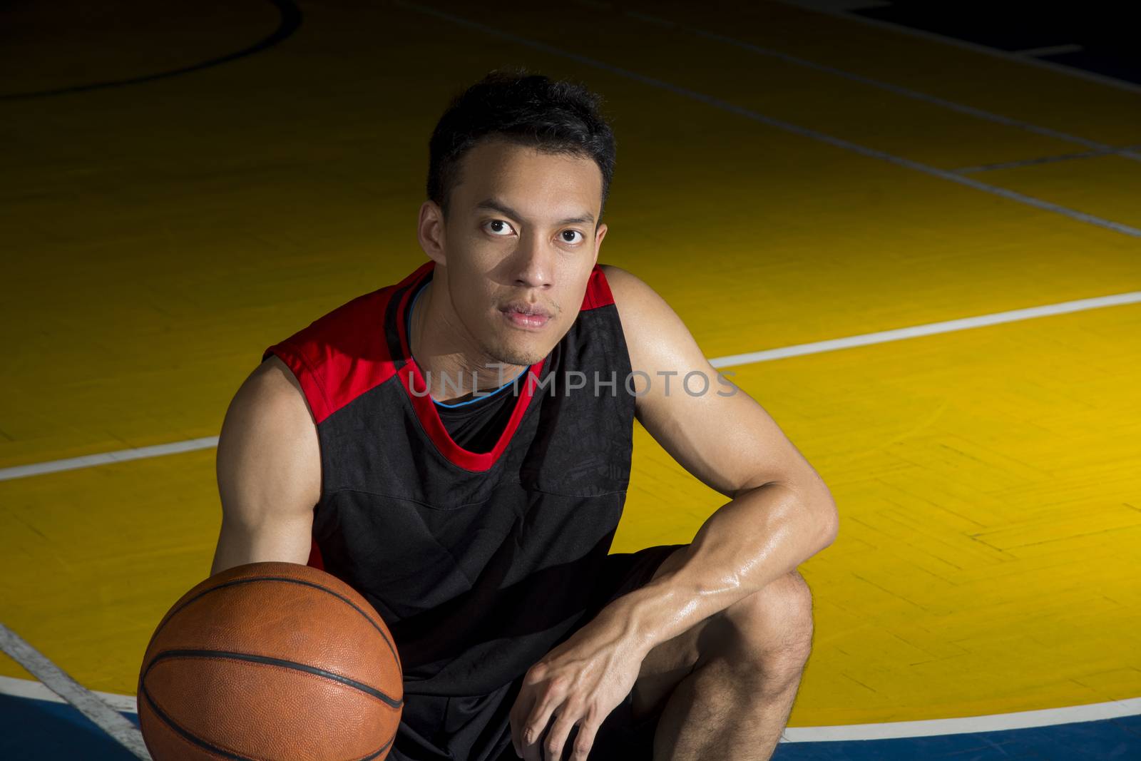 Asian young basketball player on basketball court