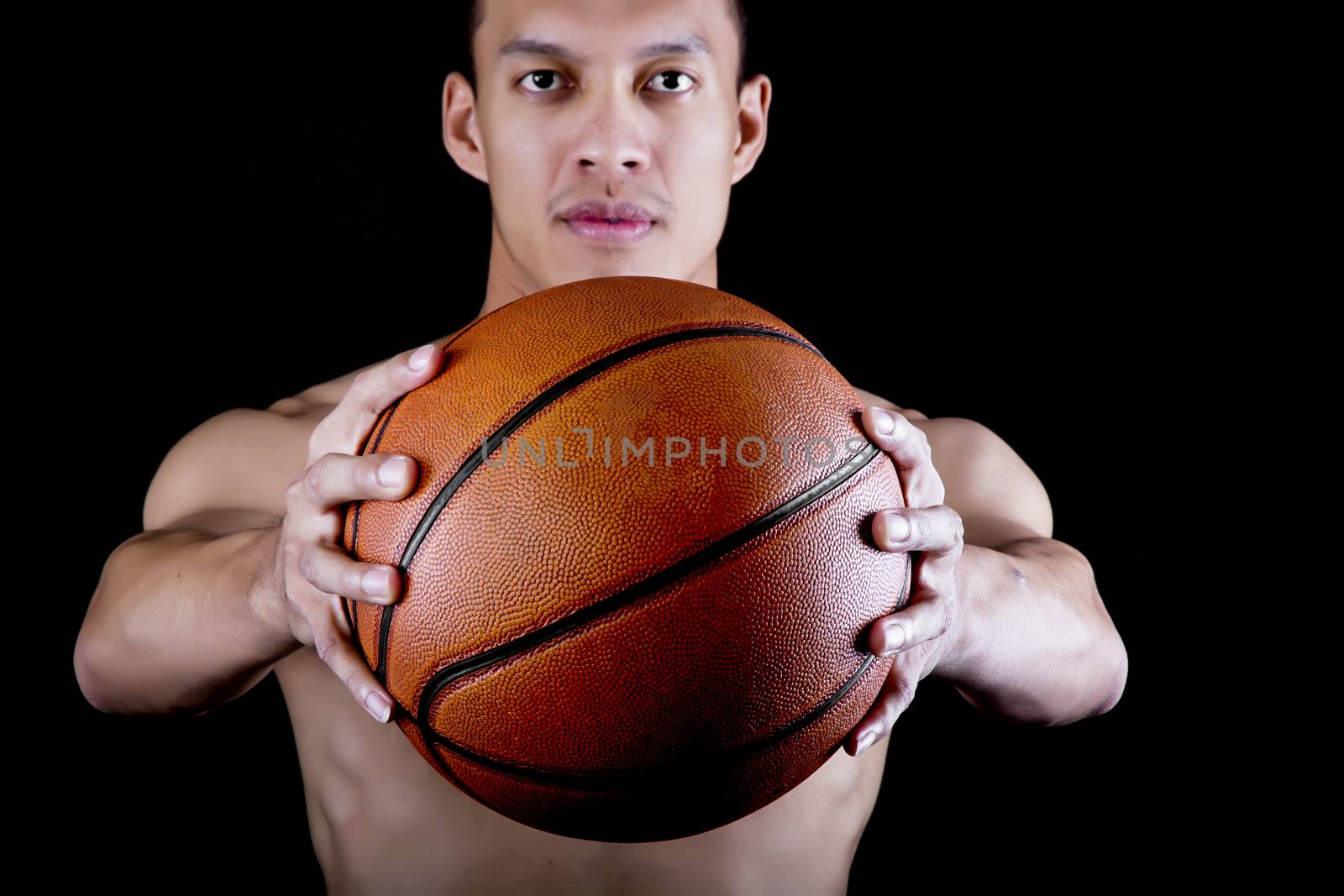 Asian young basketball player on black background
