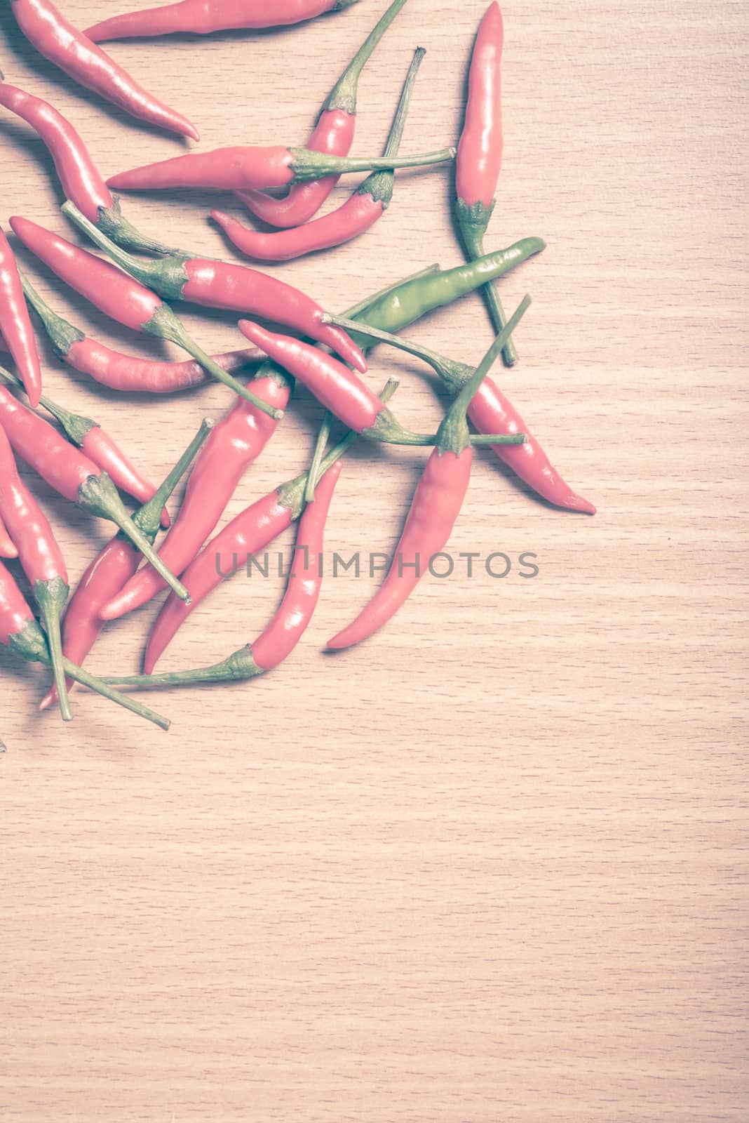 red chili peppers on wood table background vintage style