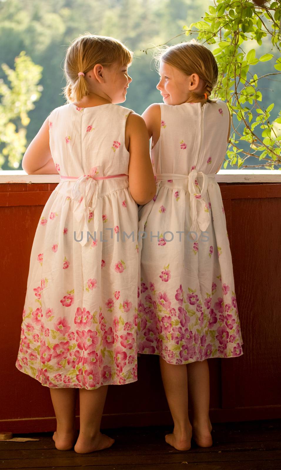 Twin girls in summer dresses by kavring