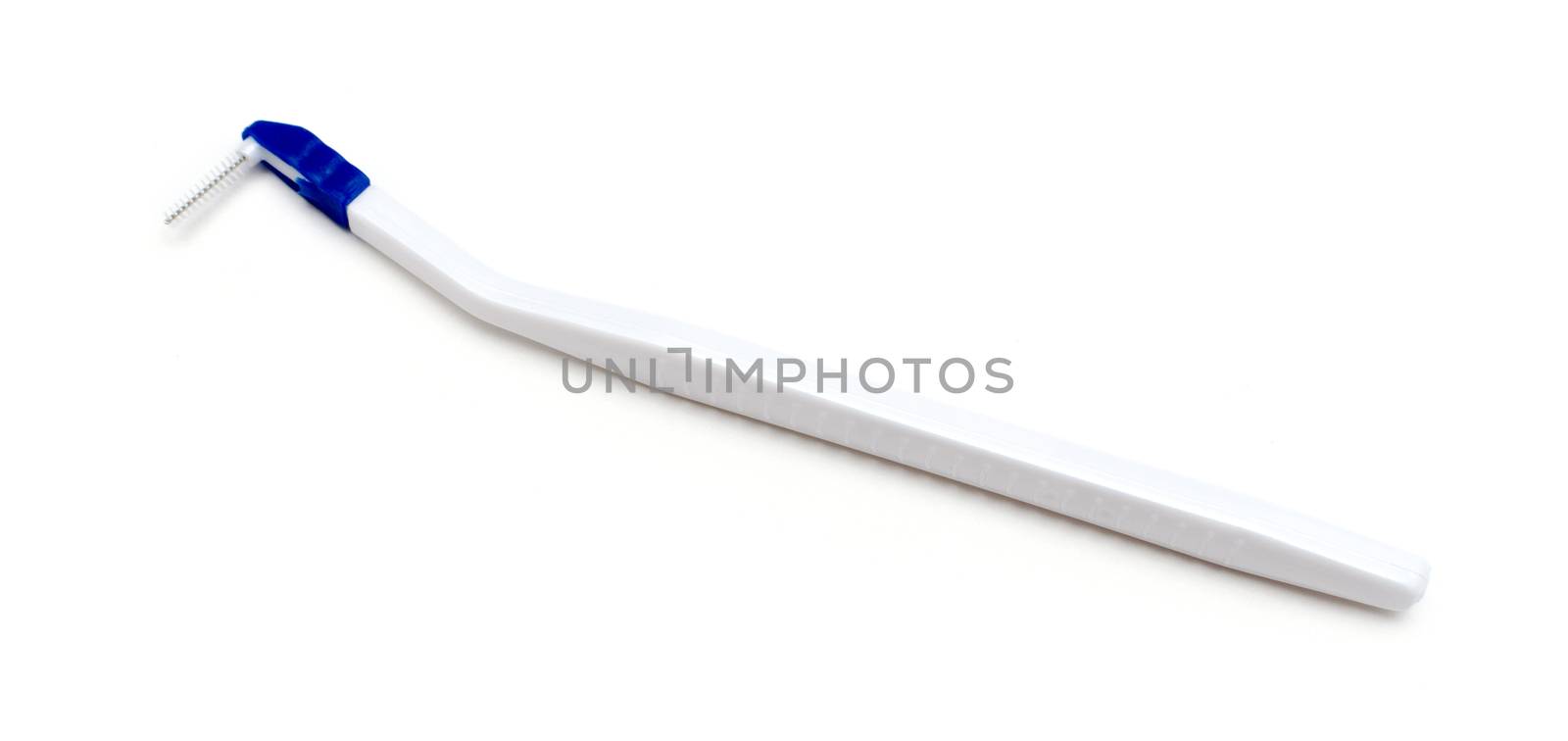 toothbrush between the teeth on an isolated white background