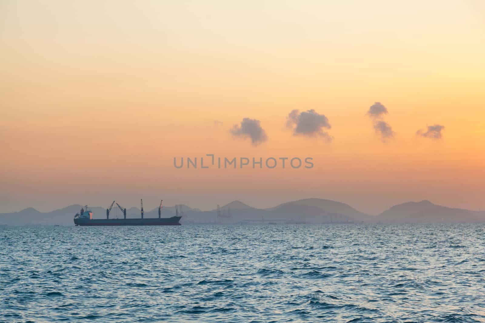 cargo ship in the morning. Morning orange sunlight Clouds covered the sky