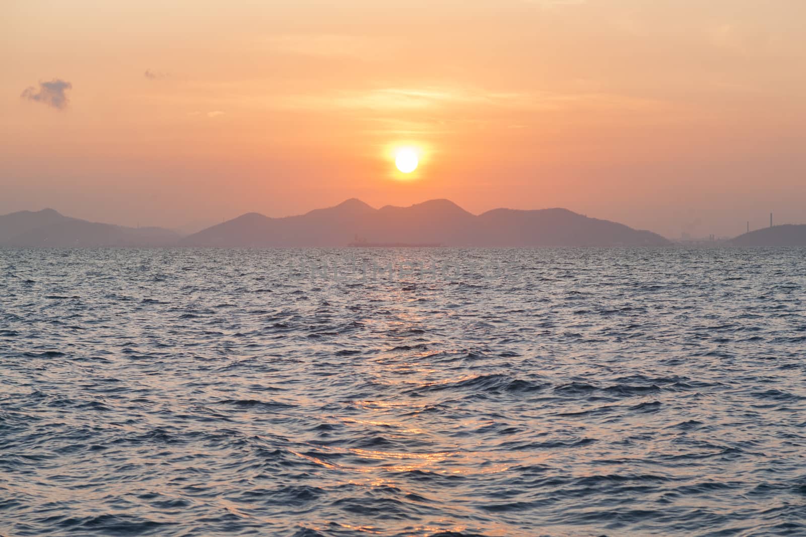 sunrise in the morning. A scene with mountains and sea front.