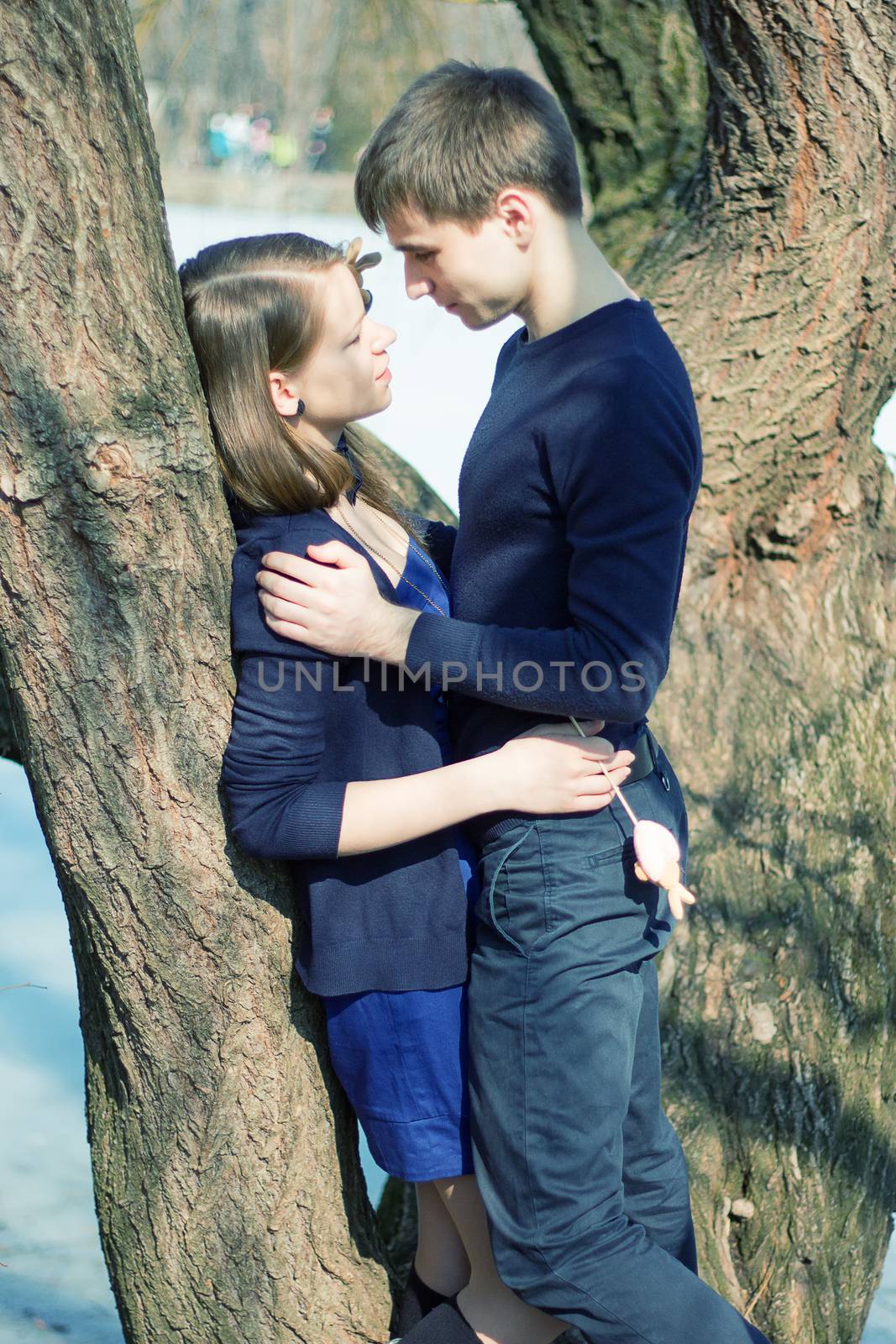 Romantic Teenage Couple By Tree In Autumn Park