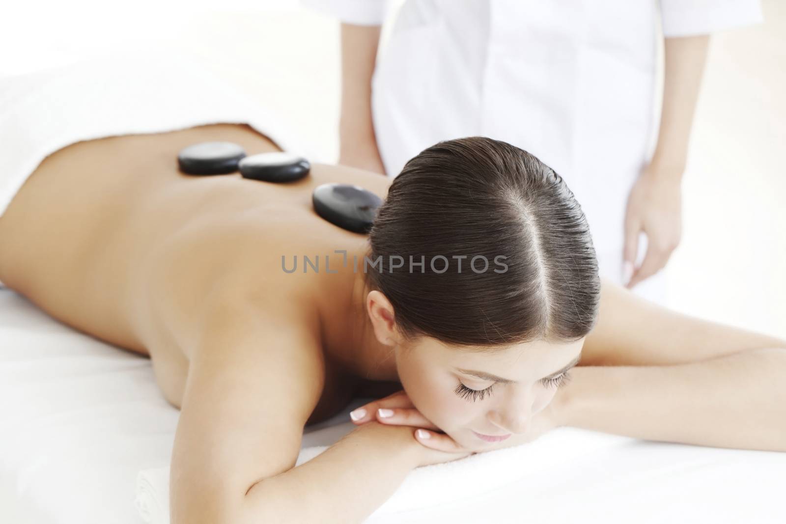 Girl on a stone therapy, hot stone massage