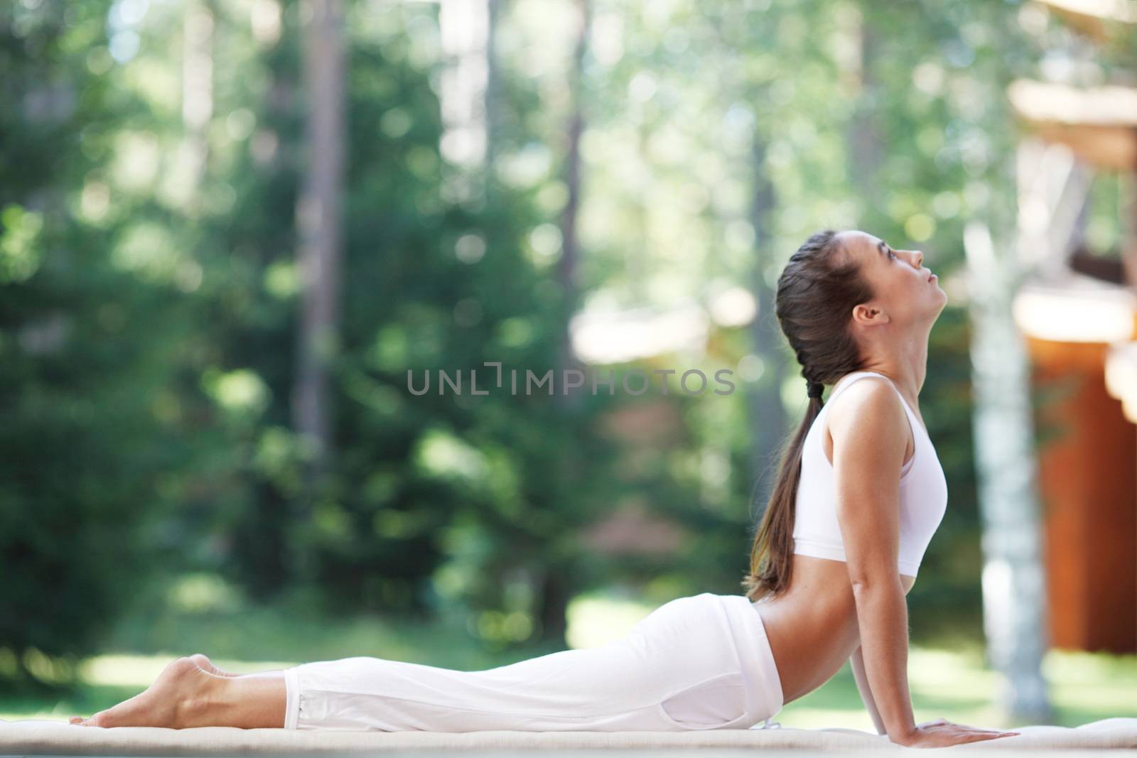 beautiful young woman doing yoga at park