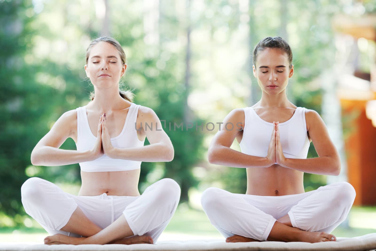 group of women doing yoga at park