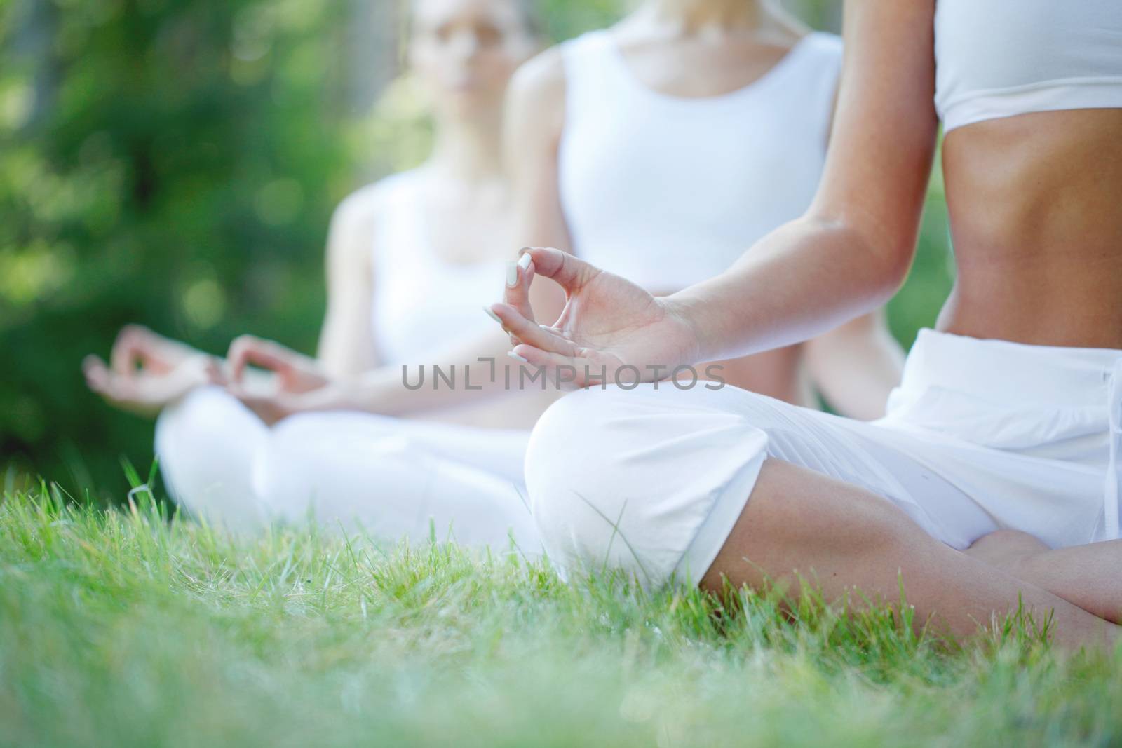 group of women doing yoga at park