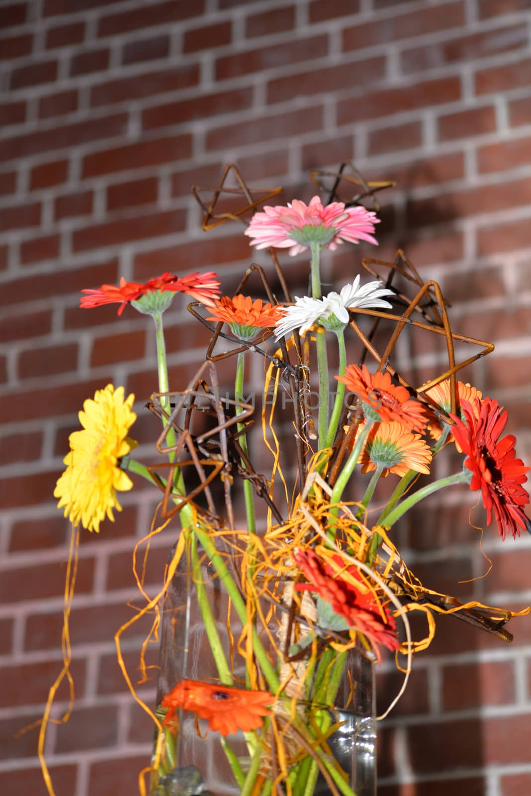 flowers in a vase against a wall by morrbyte