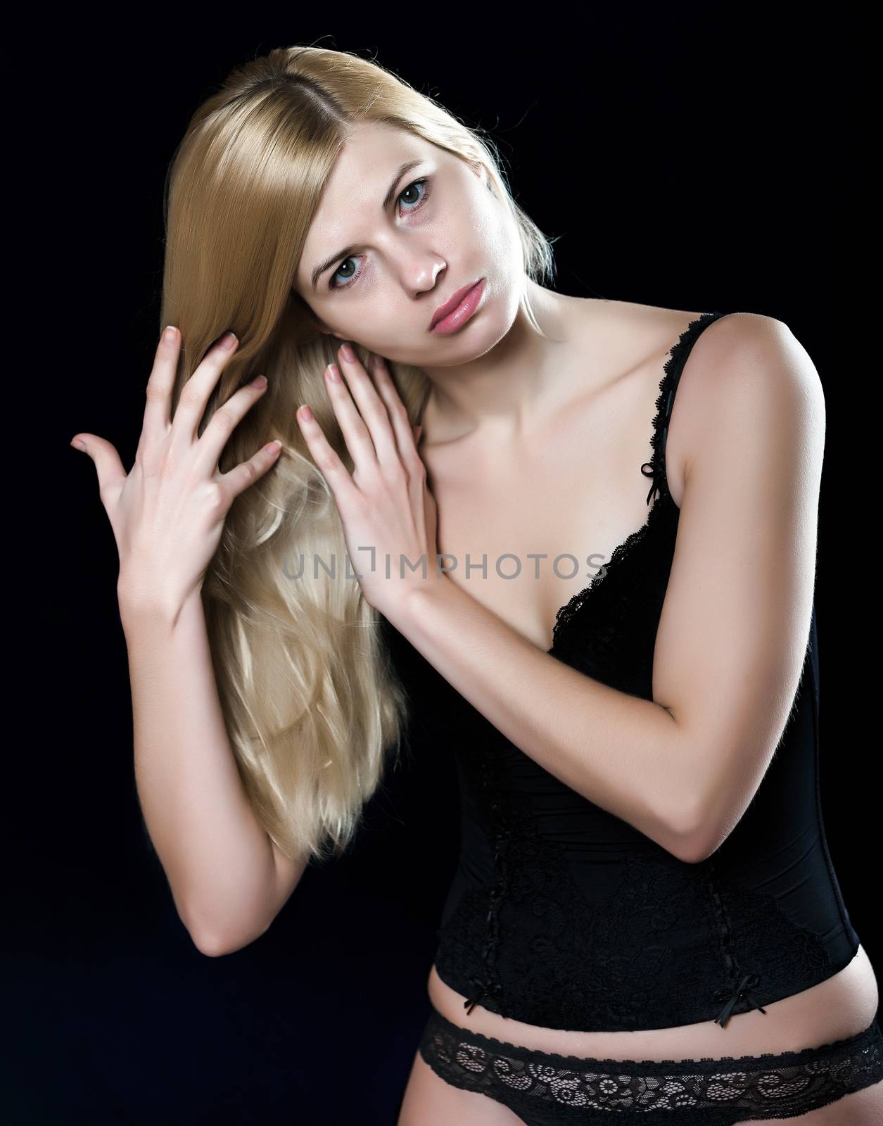 Young blond woman touching her hair by vladimir_sklyarov