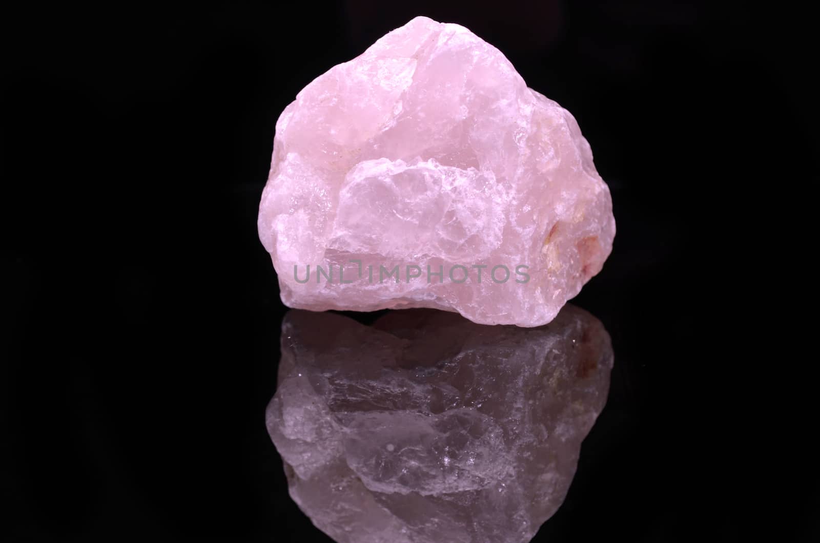 Sample of a beautiful Rose Quartz nature specimen isolated on black background