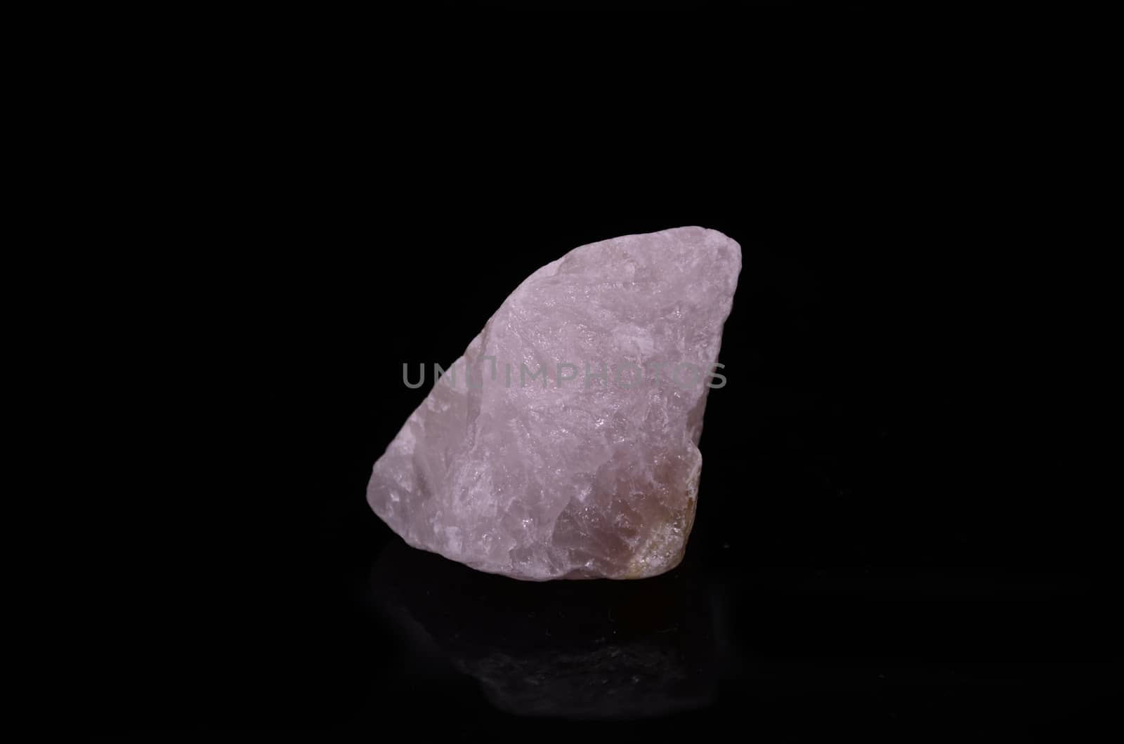 Sample of a beautiful Rose Quartz nature specimen isolated on black background