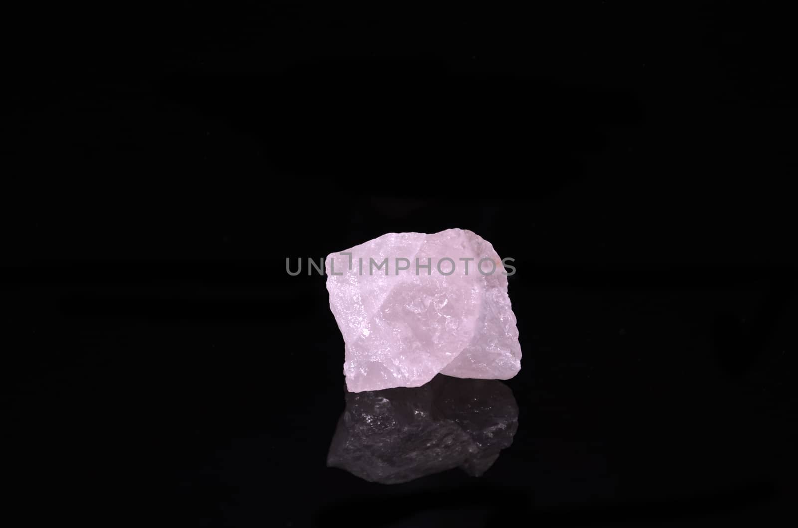 Sample of a beautiful Rose Quartz nature specimen isolated on black background