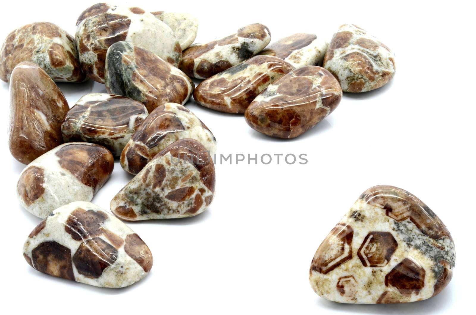 Set of a beautiful tumbled Limestone Garnet semiprecious stones isolated on white