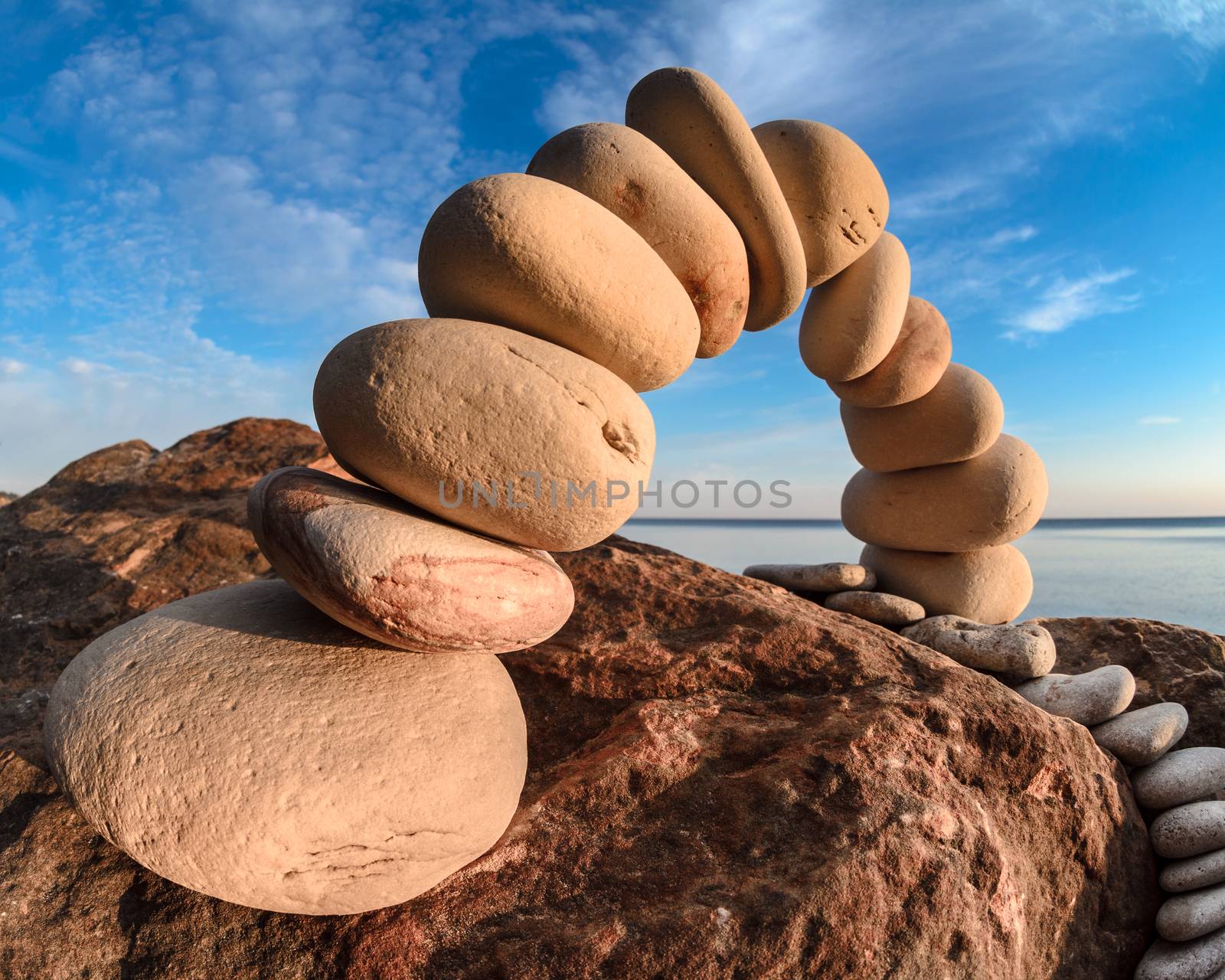 Pebbles laid out in the form of a arch on the stony coast