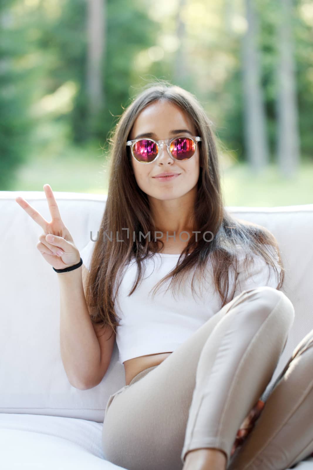 portrait of beautiful young woman siitng on couch