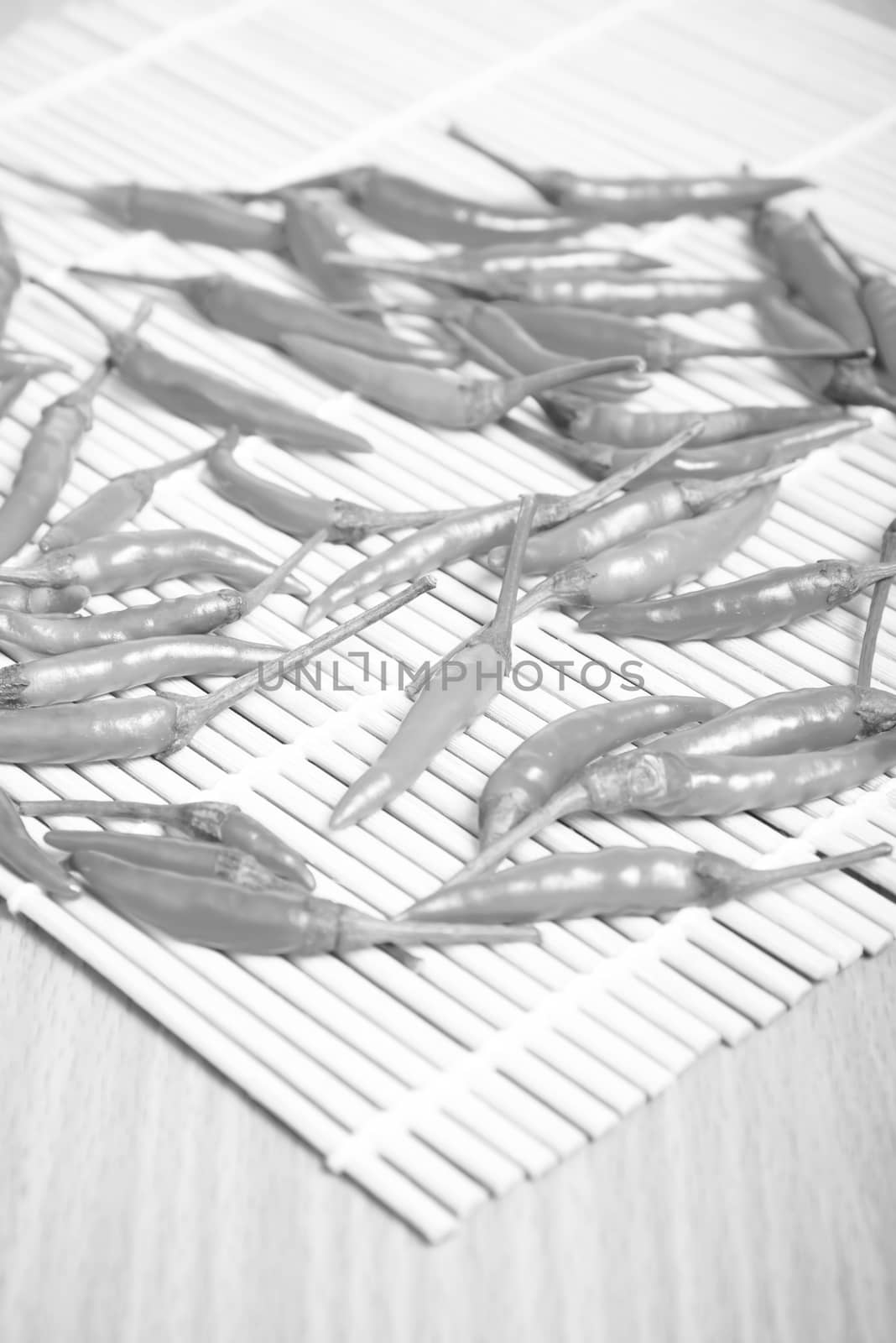 red chili peppers on wood table background black and white tone color style