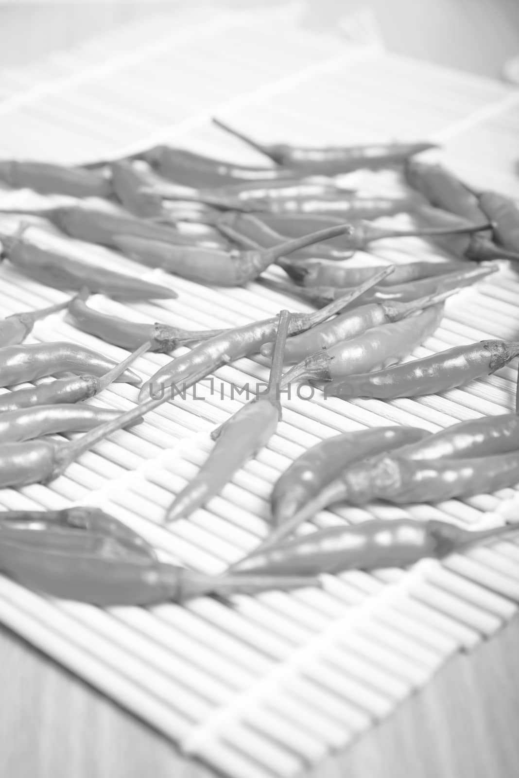 red chili peppers on wood table background black and white tone color style