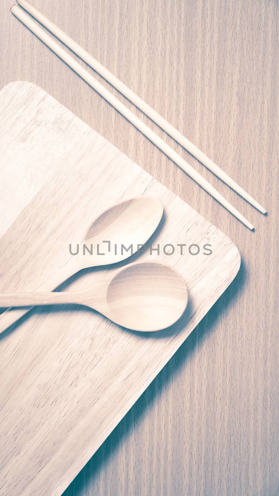 wood spoon with cutting board on table background vintage style