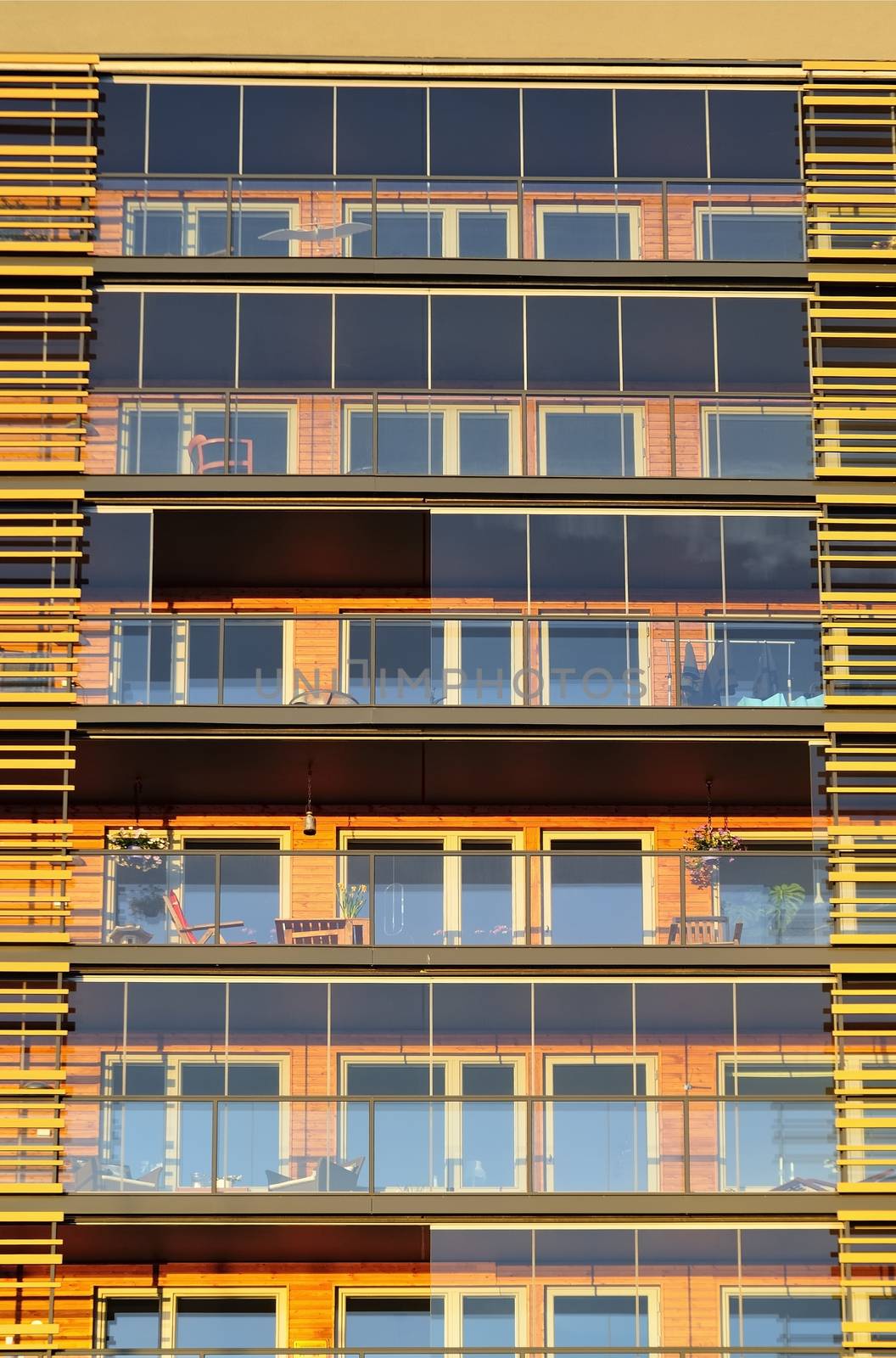 Balconies on the side of a building with many windows.