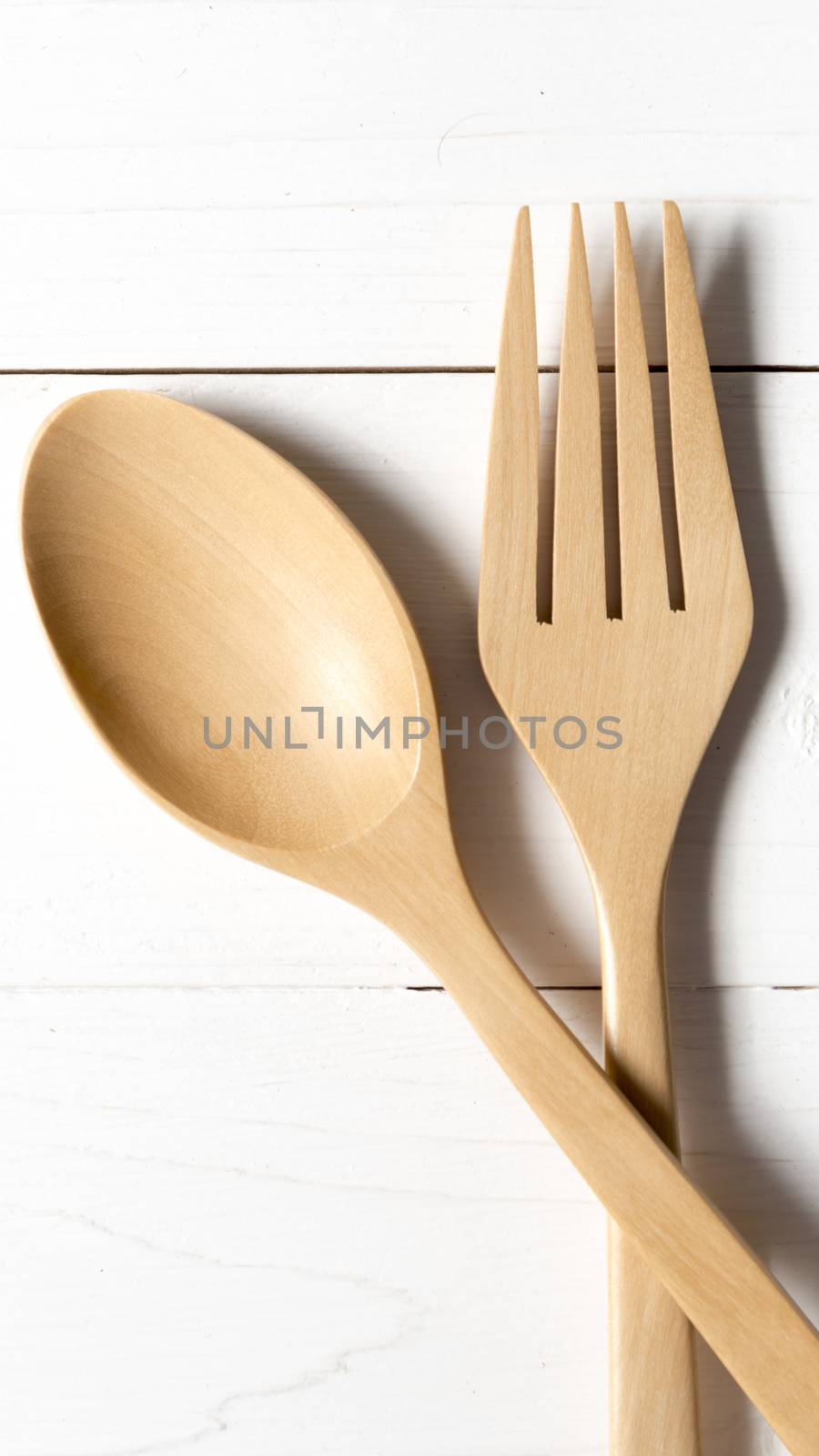 wood spoon and fork over white table background