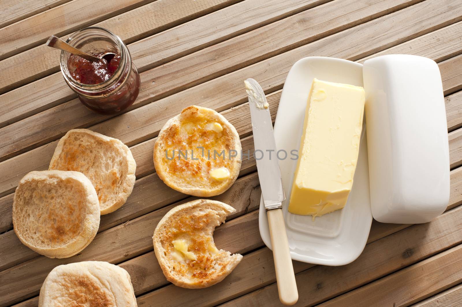 English Muffins, Butter and Jam on Wooden Table by stockarch